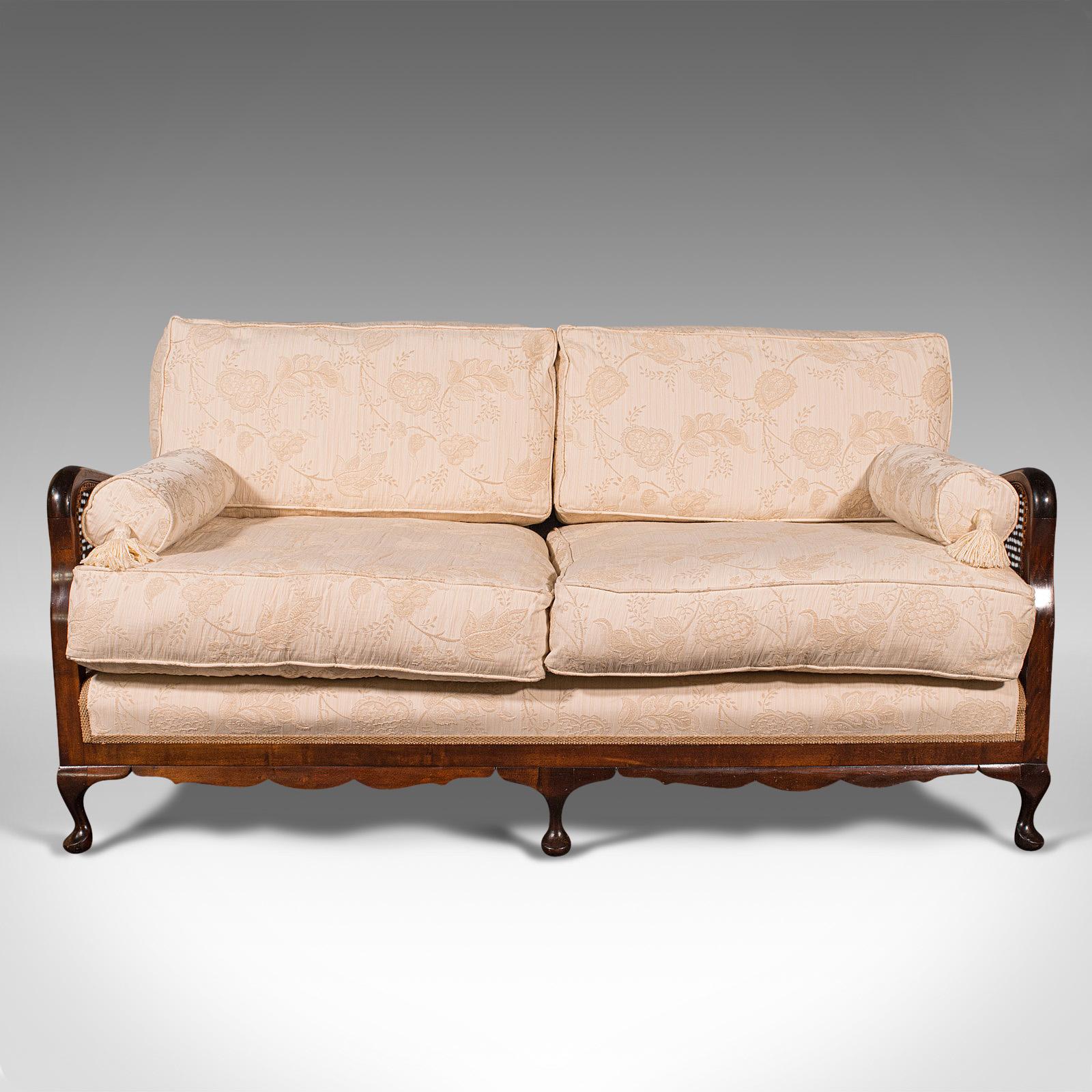 This is an antique bergere sofa. An English, beech and cane two seat settee, dating to the Edwardian period, circa 1910.

Presenting beautifully, a delightful living room or conservatory sofa
Displays a desirable aged patina and in good