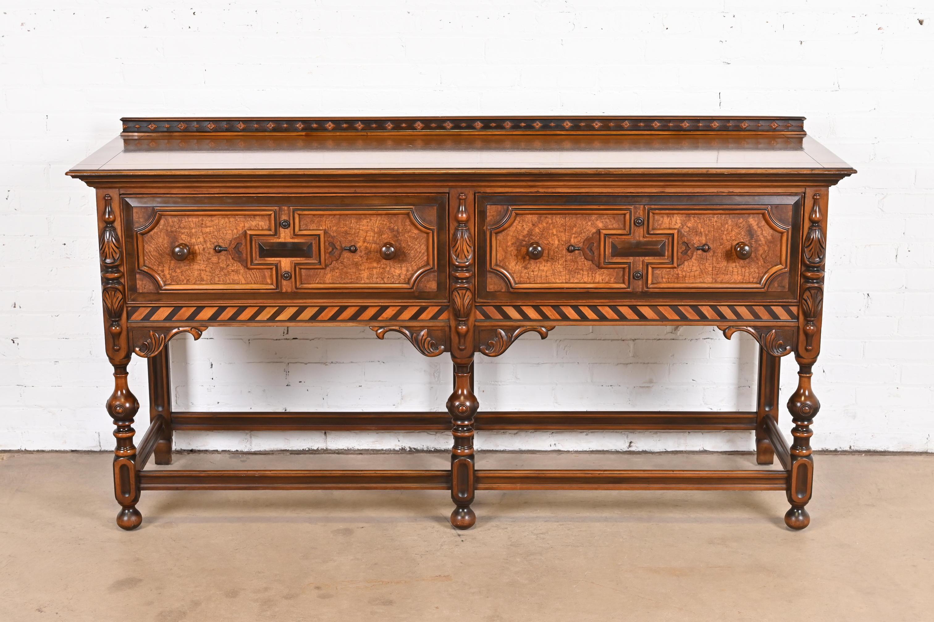 An exceptional English Jacobean style sideboard buffet or credenza

By Berkey & Gay

USA, Circa 1920s

Ornate carved walnut, with inlaid burl wood drawer fronts.

Measures: 72