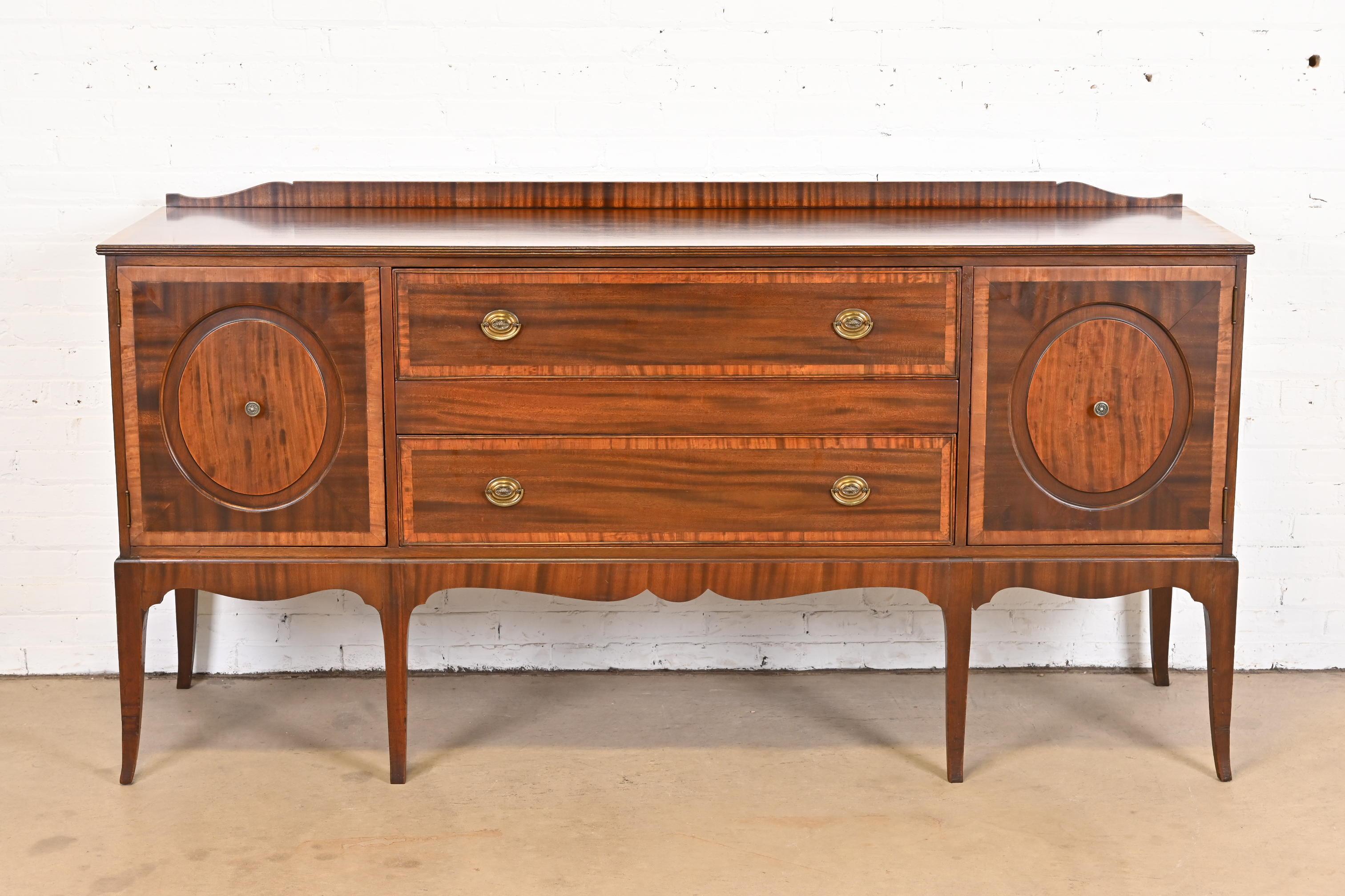 A gorgeous antique Regency style sideboard buffet or credenza

By Berkey & Gay

USA, circa 1920s

Beautiful inlaid banded mahogany, with original brass hardware.

Measures: 78