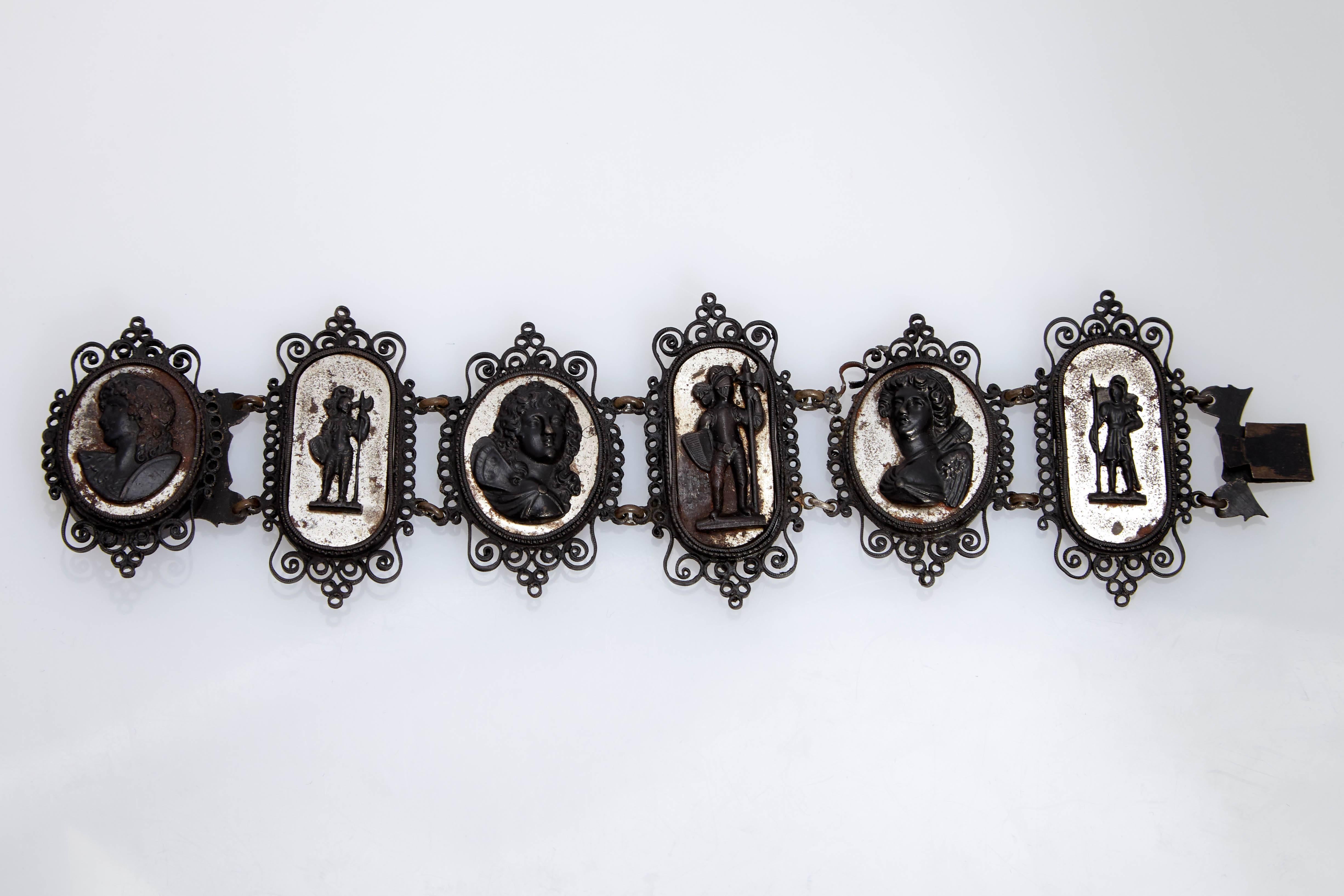 Berlin iron bracelet of six joined cameos surrounded by openwork motifs (black lacquered cast iron).  Berlin, circa 1800s.