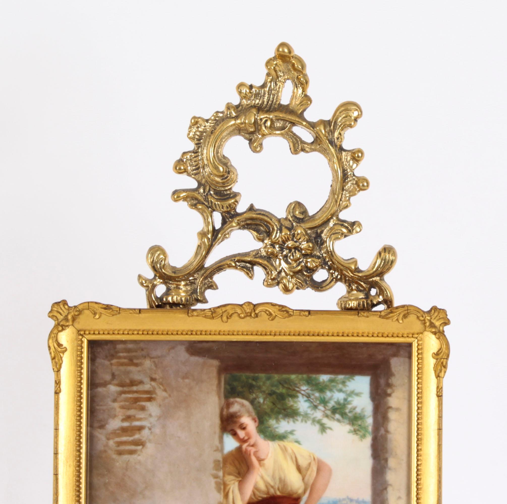 This is an absolutely stunning and finely painted KPM Berlin Plaque after Paul Thumann's (1834-1908) 'Kunst Bringt Gunst' (meaning 'Art wins heart'), signed Knouller and raised on a decorative gilt bronze easel stand, circa 1880 in date.
 
 This