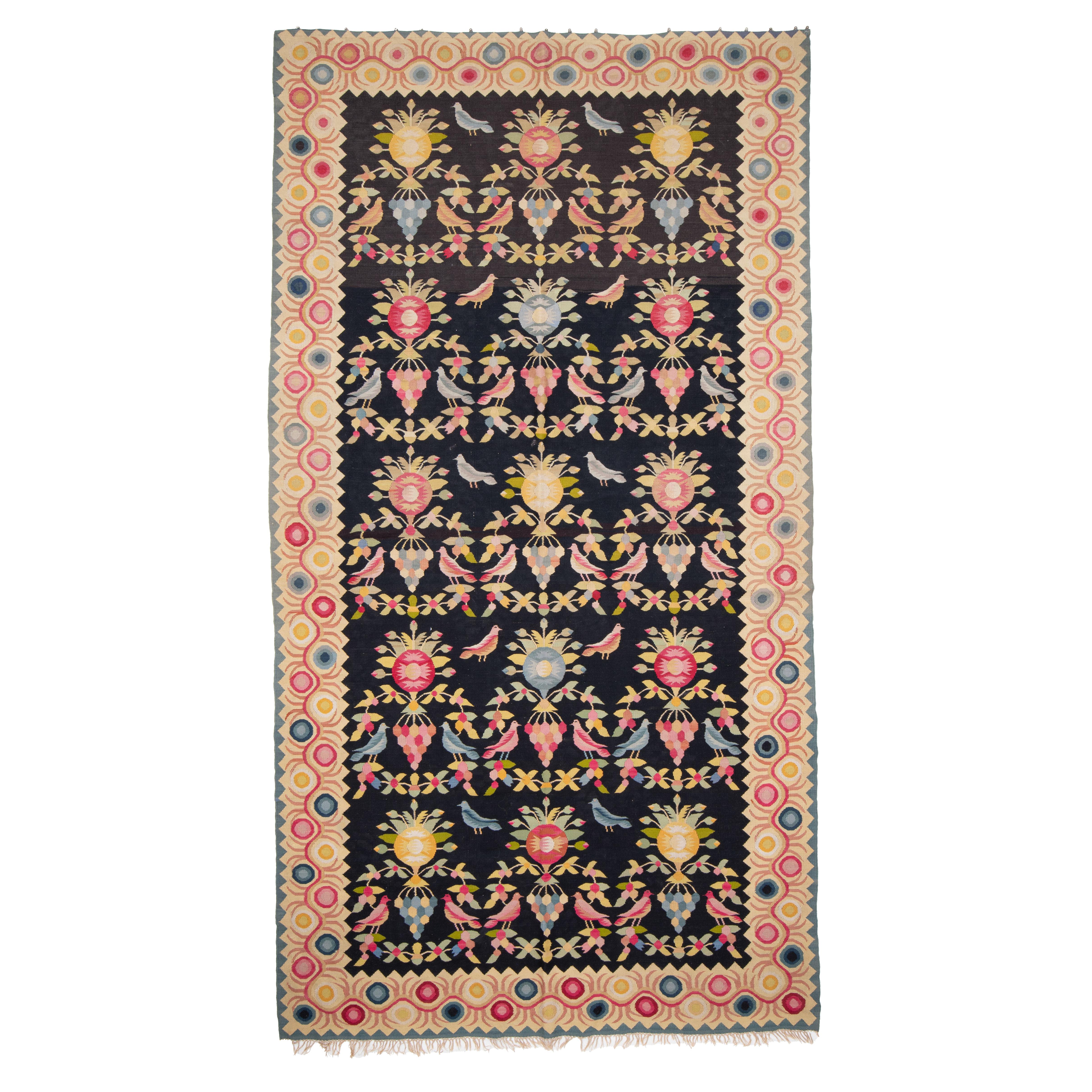 In its previous life this kilim was used as a curtain. One end still has the curtian buttons.
Over all condition is good and colours are vibrant and all natural. UNusual design,
Please note , it is an antique and used piece therefore it is not in