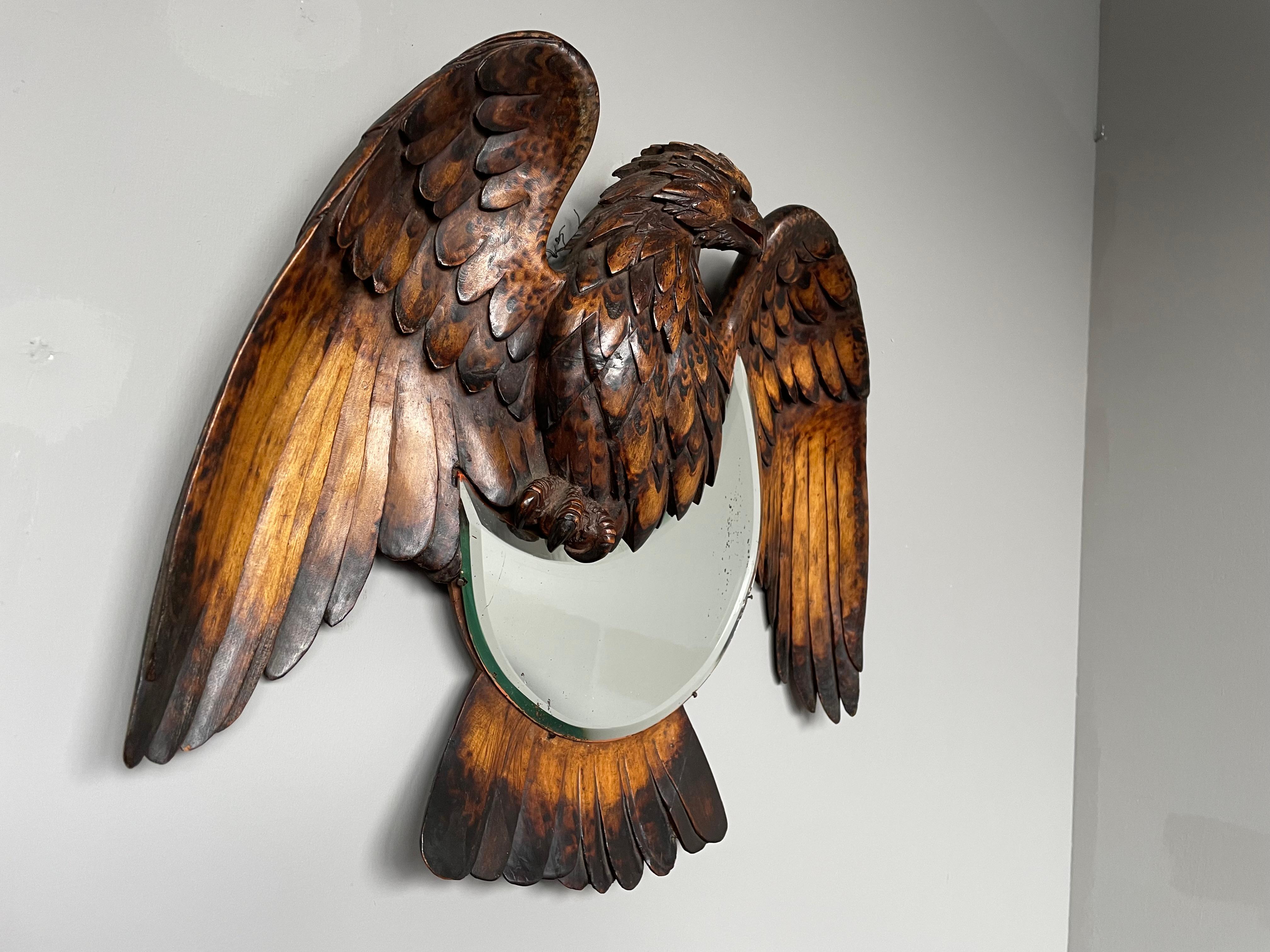 Rare and beautifully hand carved eagle sculpture on a crescent moon design mirror.

If you are appreciative of rare and sculptural antiques then this Swiss Black Forest wall mirror could be exactly what you are looking for. The quality in both the