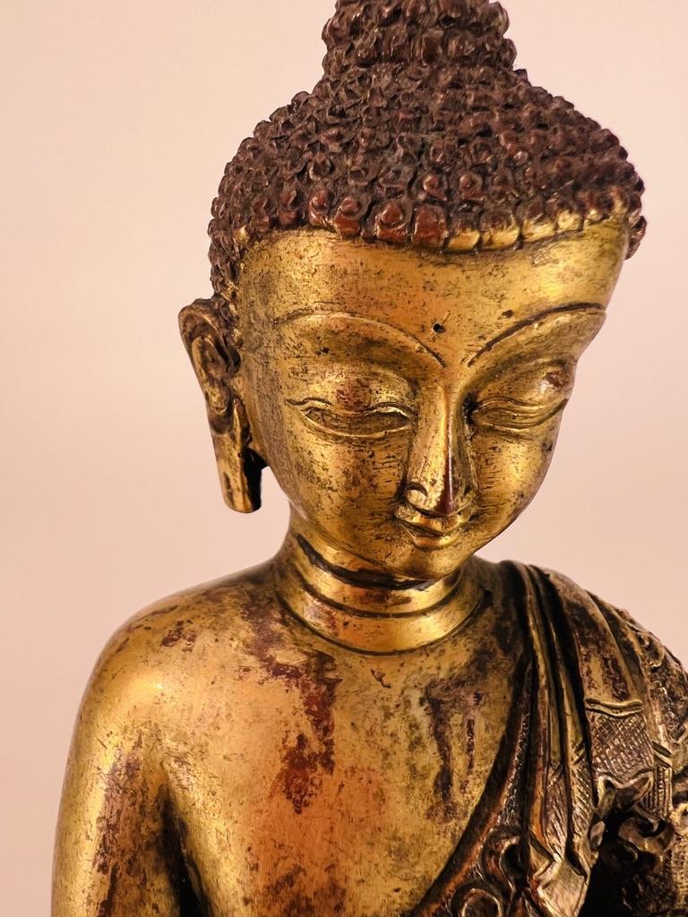Bronzed Antique Bhutanese bronze depicting Buddha with excellent chiseling. For Sale