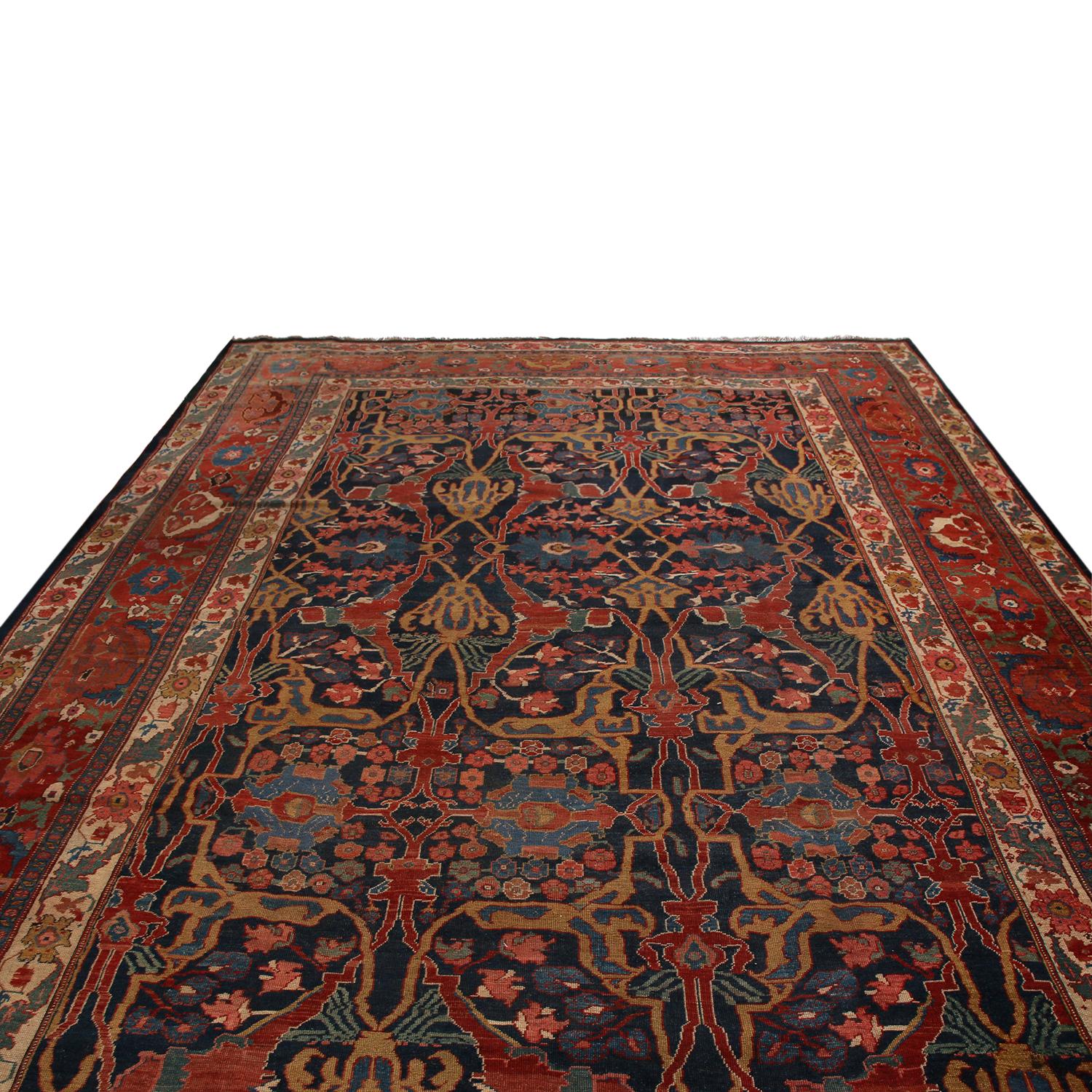 Originating from Persia between 1900-1910, this antique Bidjar Persian rug enjoys tasteful highlights of complementary bronze-orange and gentle green hues accenting the burgundy red and Egyptian blue colorways throughout the field and border. Hand