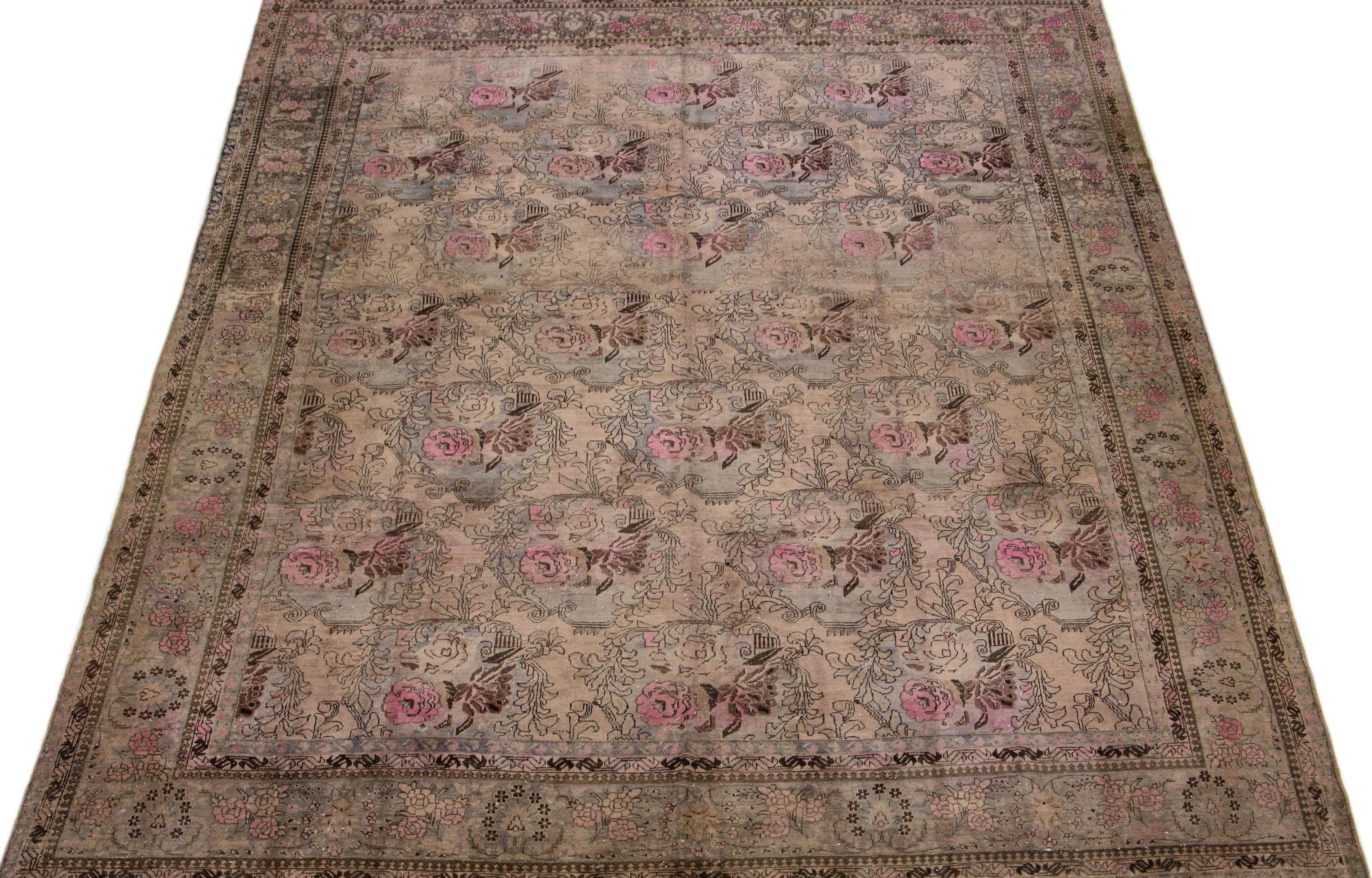 Beautiful antique Bidjar hand-knotted wool rug with a brown color field. This Persian rug has gray and pink accents in a gorgeous traditional floral design.

This rug measures 10'7