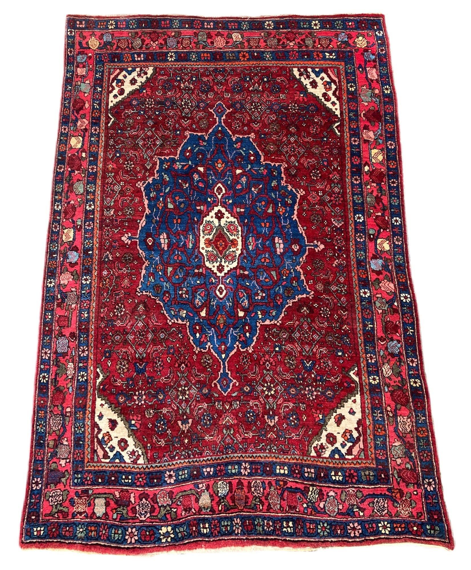 A wonderful antique Bidjar rug, hand woven circa 1920. The design features a central indigo medallion on a traditional Herati design red field. Finely woven with lovely wool quality and great secondary colours.
Size: 1.61m x 1.12m (5ft 4in x 3ft