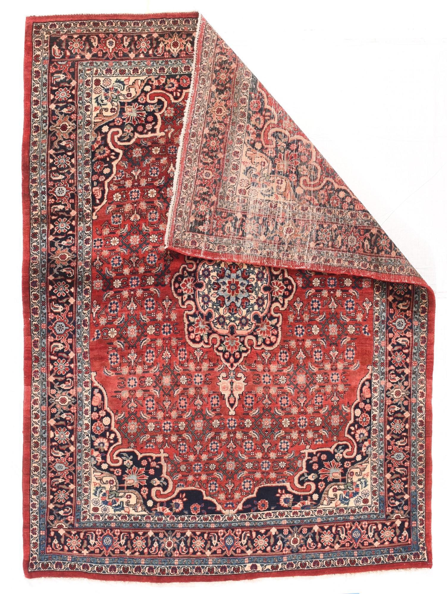 Antique Bidjar rug 4'10'' x 6'6''. The gently abrashed tomato Madder field shows a small Herati design flowing around a navy eight crenel medallion with an ecru sub-medallion. Conjoint navy corners show arabesque points and hooks from the field.