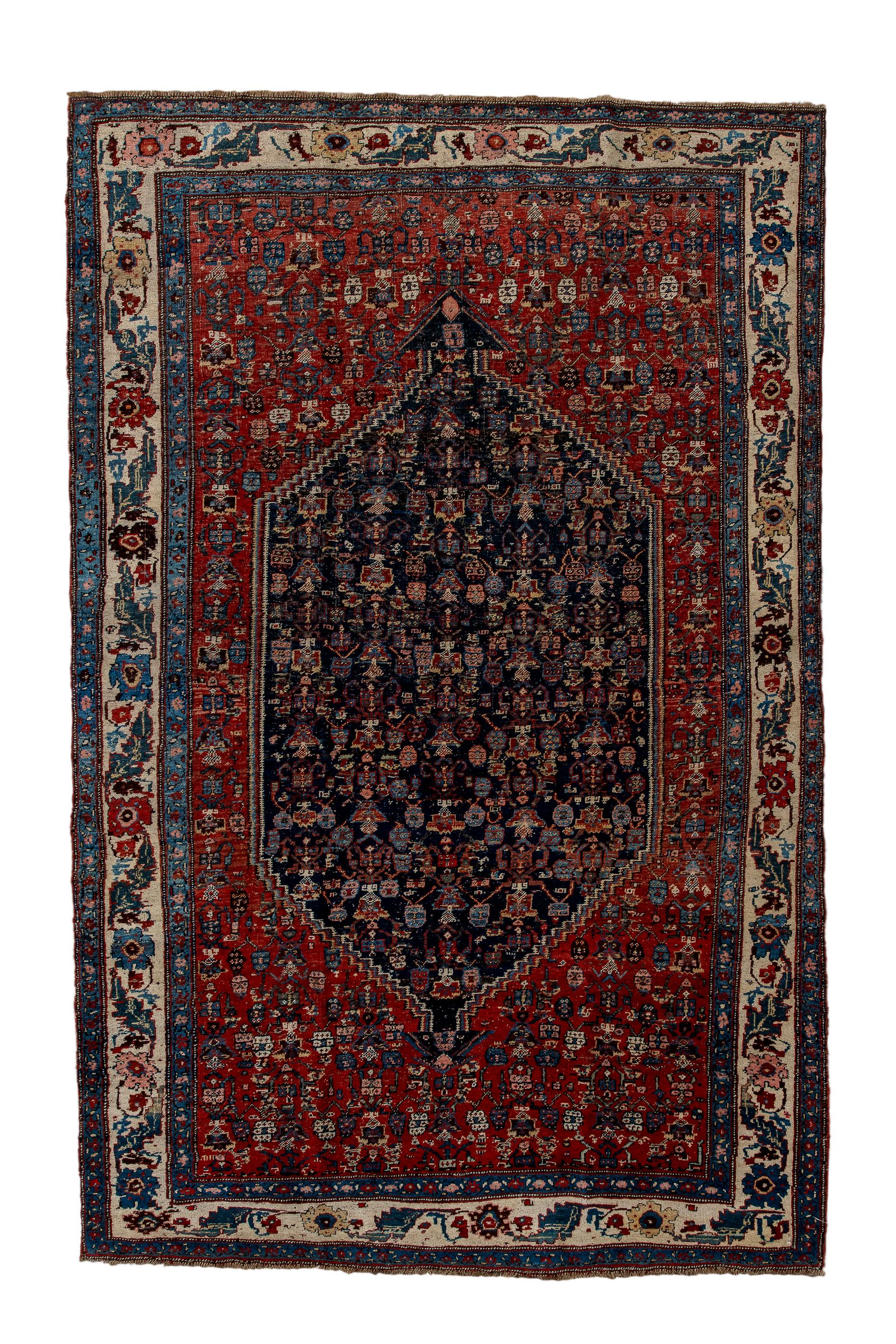 Bidjar Kurdish city rugs are always robust and solid, and this one with a red field of small flowers is no exception. The navy subfield is stepped on the slanted ends and displays a rough variant of the allover Herati design. The ecru main border