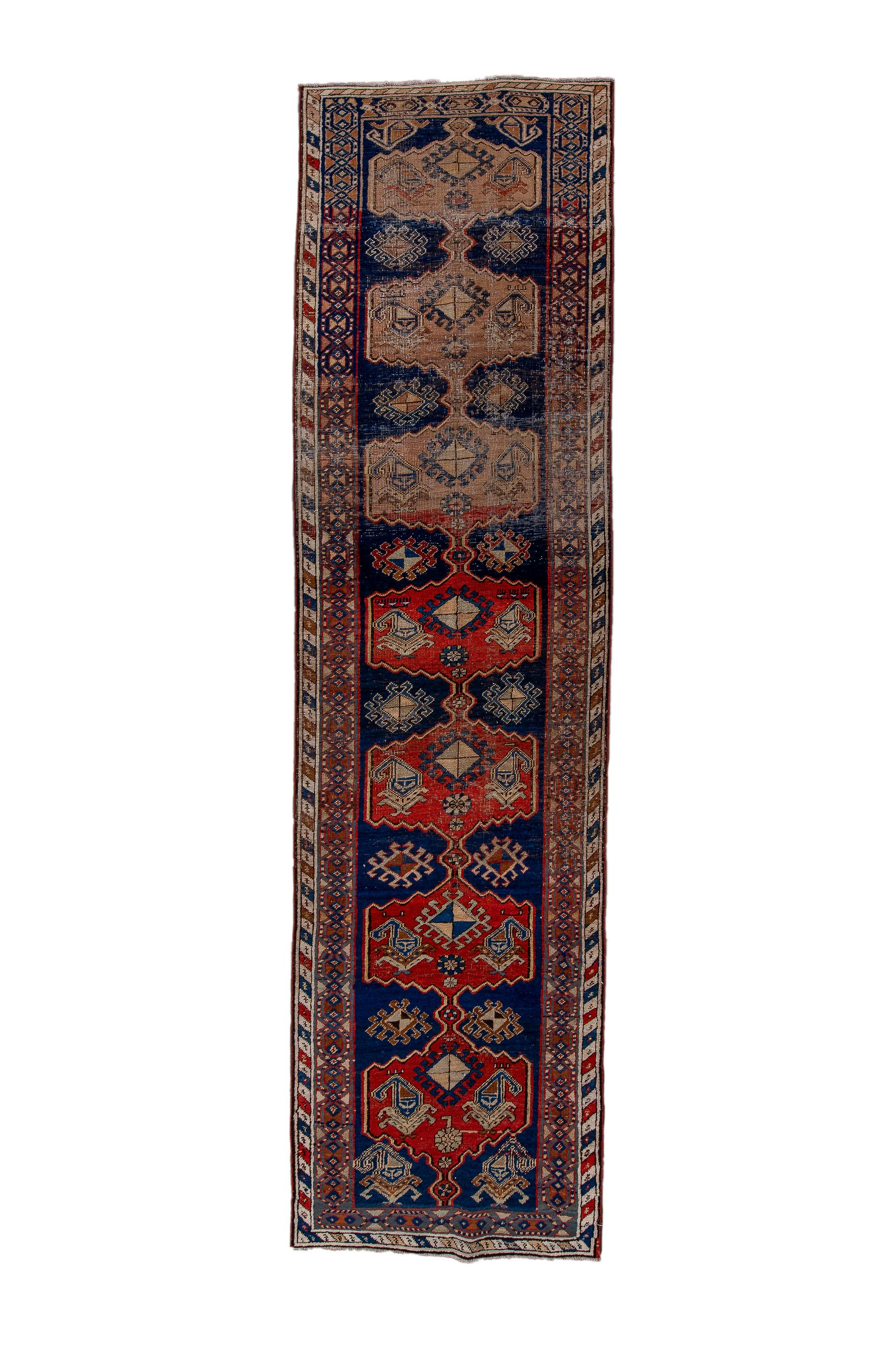 This village Bidjar runner shows a royal blue field with a pole medallion of  seven abrashed red cartouches, uniformly enclosing  boteh-flowers, with hooked lozenges in the lateral reserves. Main border with ivory and coloured diagonal stripes. 