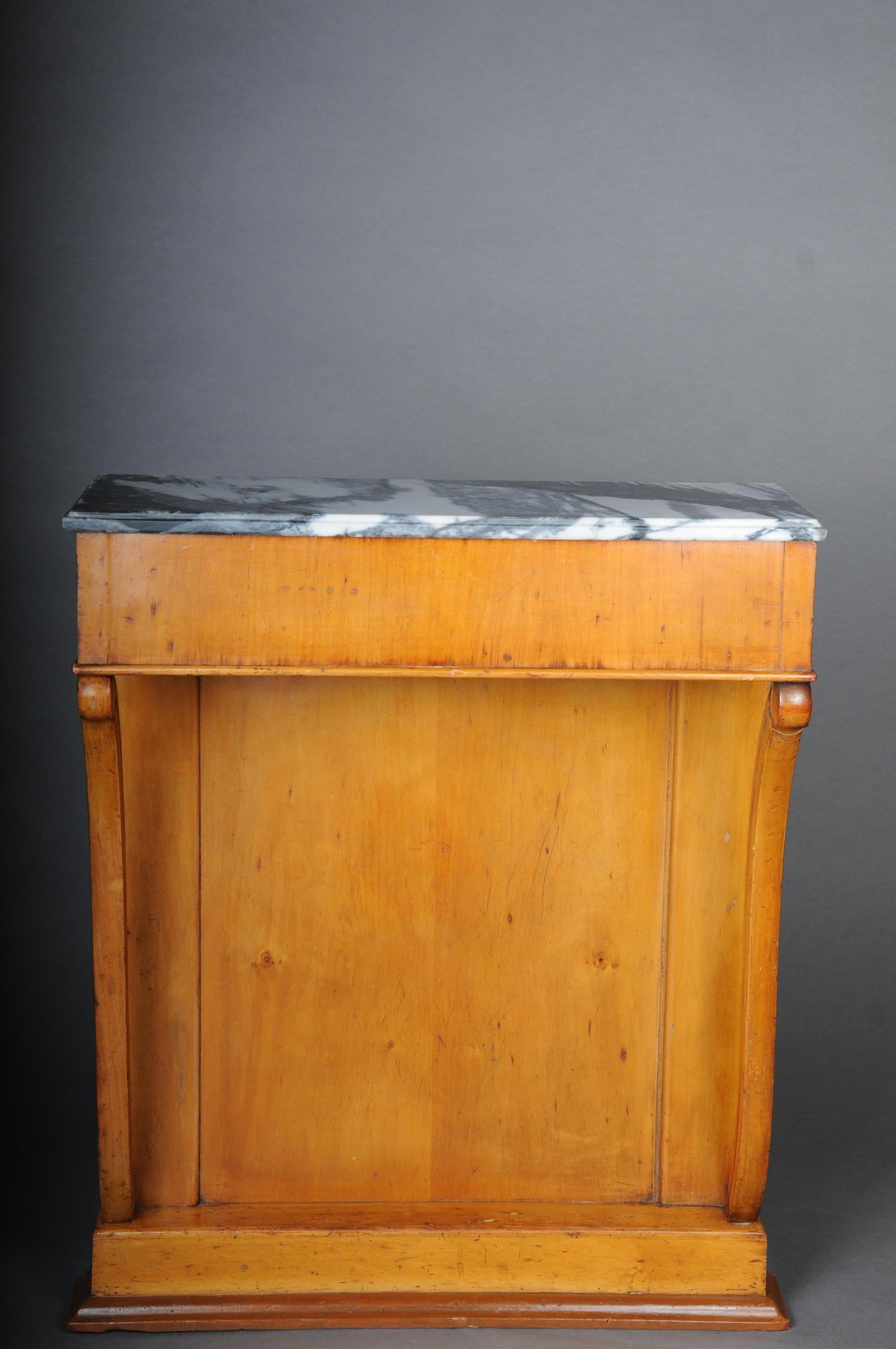 Antique Biedermeier console circa 1830, fruit wood.

Solid fruit wood body with 2 curved columns. Cover plate with mottled marble top. Narrow body which is ideal for narrow corridors or the like.

(E-39).