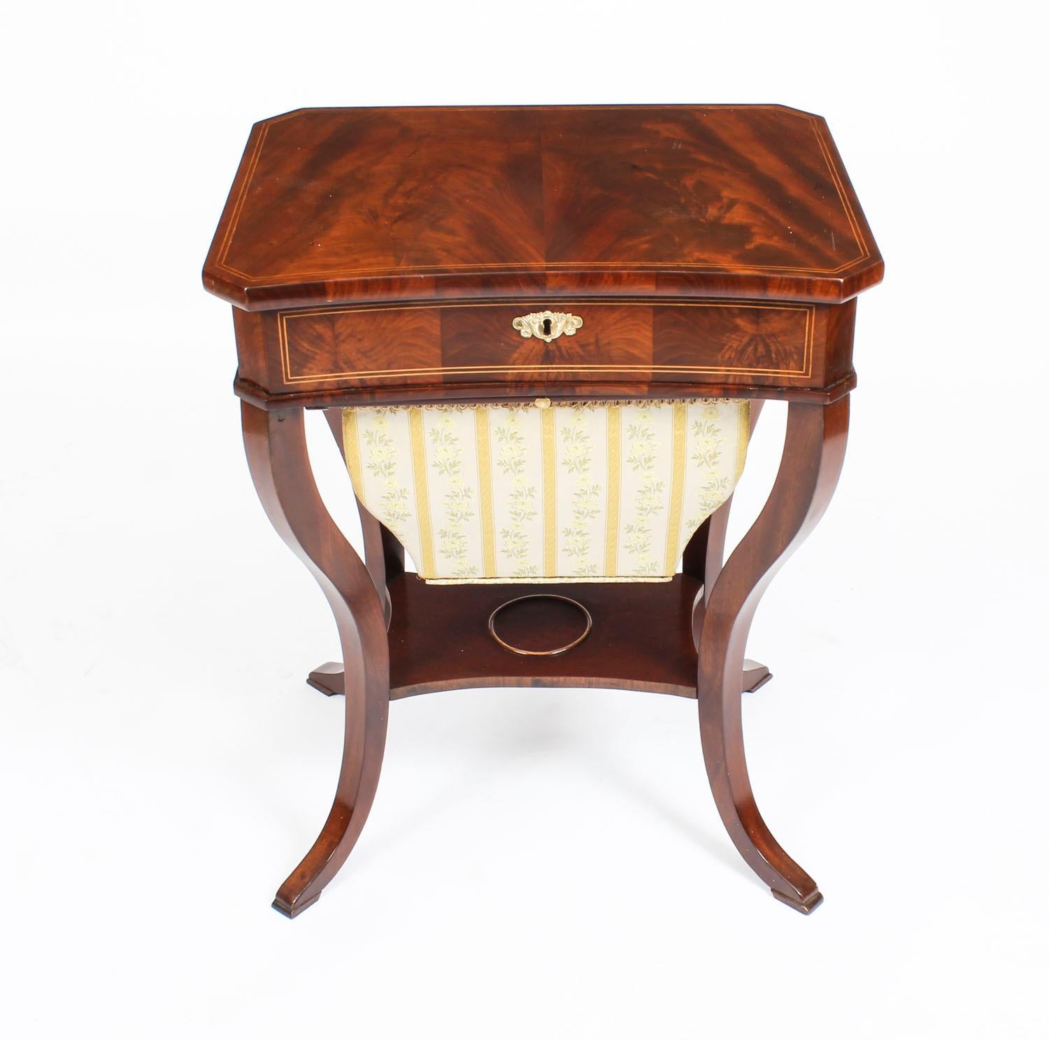 A beautiful antique mahogany Austrian Biedermeier work box circa 1820 in date.

The work table features boxwood stringing on the lift up top, the interior is fitted with various compartments some with fitted lids for your sewing items, a lift up