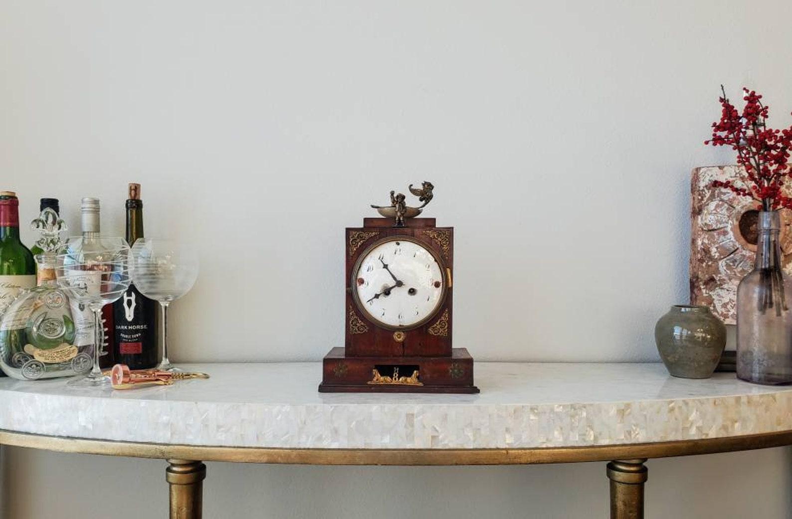 A charming and most unusual late 18th / early 19th century German mantel clock. The antique clock case is of simple form, with a fine, rich wooden finish, beautiful patina, adding unique character and complexity its adorned with various gilt bronze