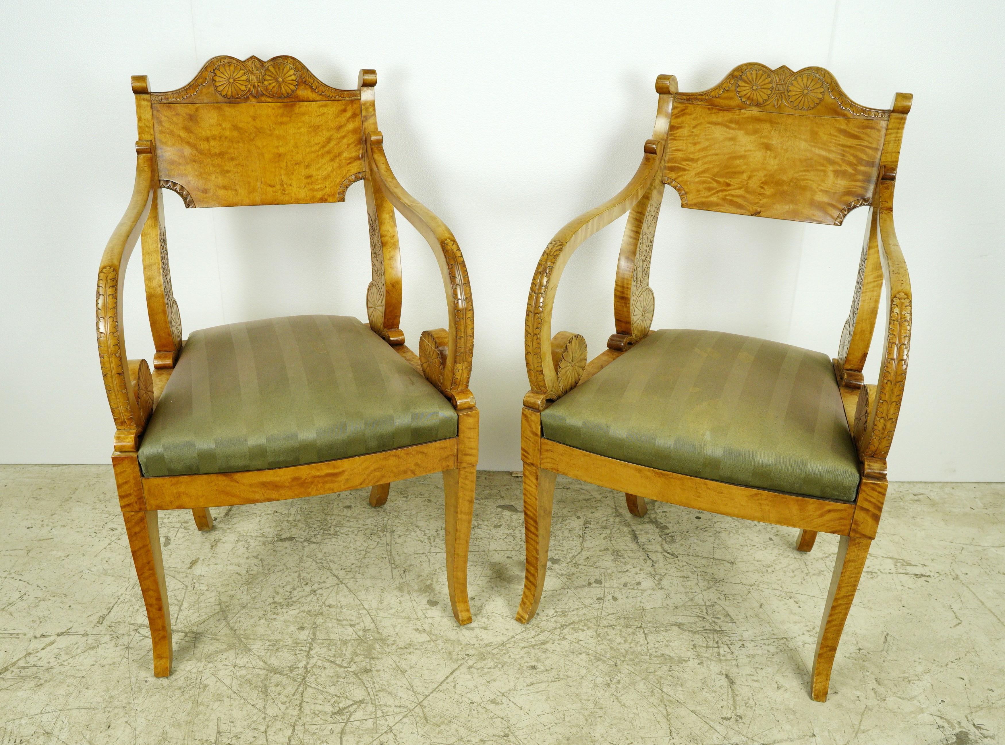 From an estate in Greenwich, Connecticut, this set reflects the sophistication and quality associated with the Biedermeier period. The two chairs feature a solid and well-built construction, showcasing carved floral and 