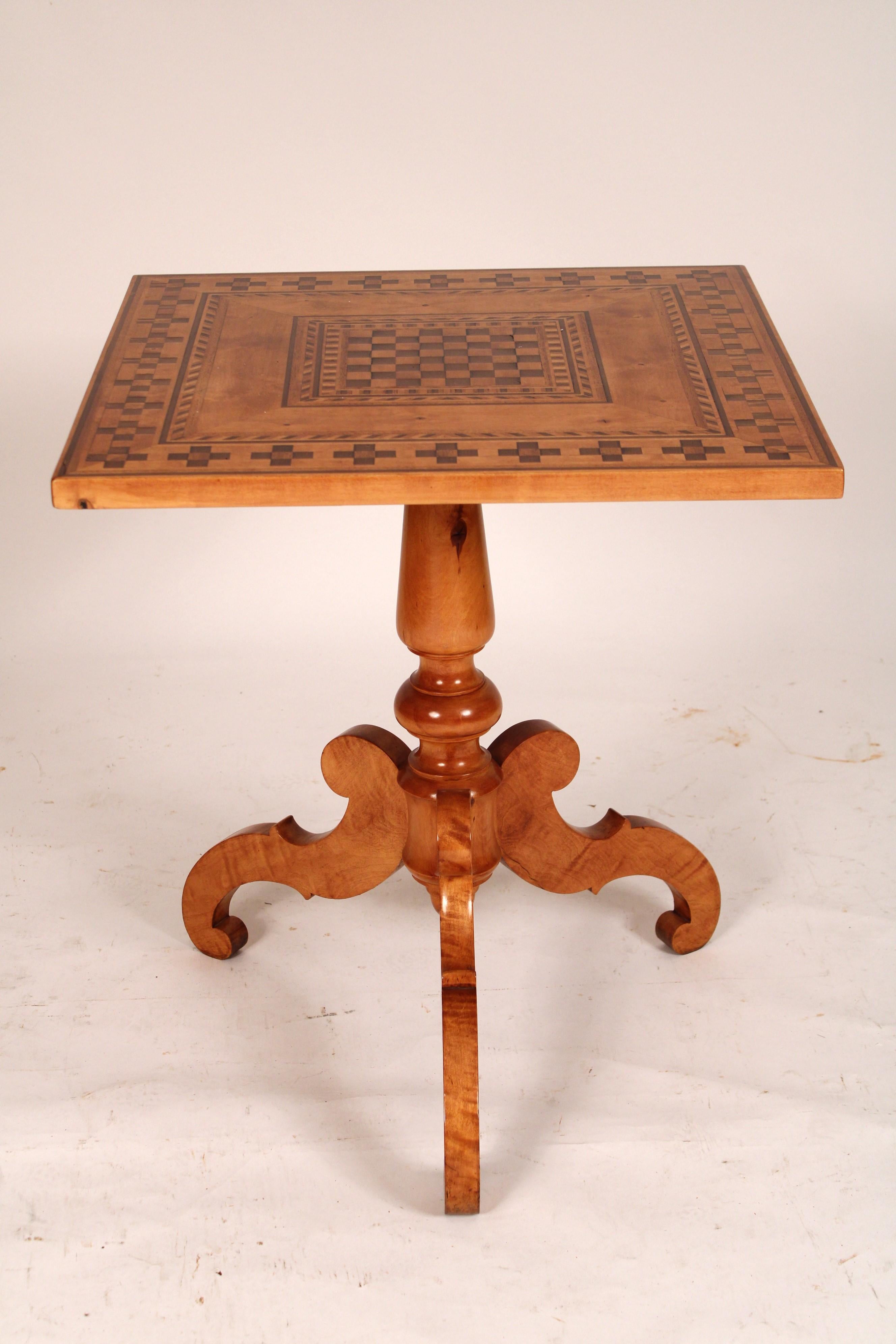 Antique Biedermeier style birch Inlaid tilt top table, circa 1900. With a square top with walnut parquetry and banding, a central turned pedestal, 3 nicely figured birch serpentine shaped legs. Both the top and base have been professionally