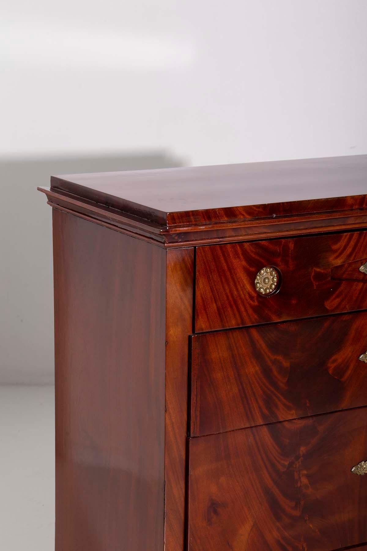 This marvelous Biedermeier-style drop-front secretary chest, dating back to around 1830 and crafted in Austria, is a true work of art. Made from precious mahogany wood, it features breathtaking grain patterns that create a magnificent visual