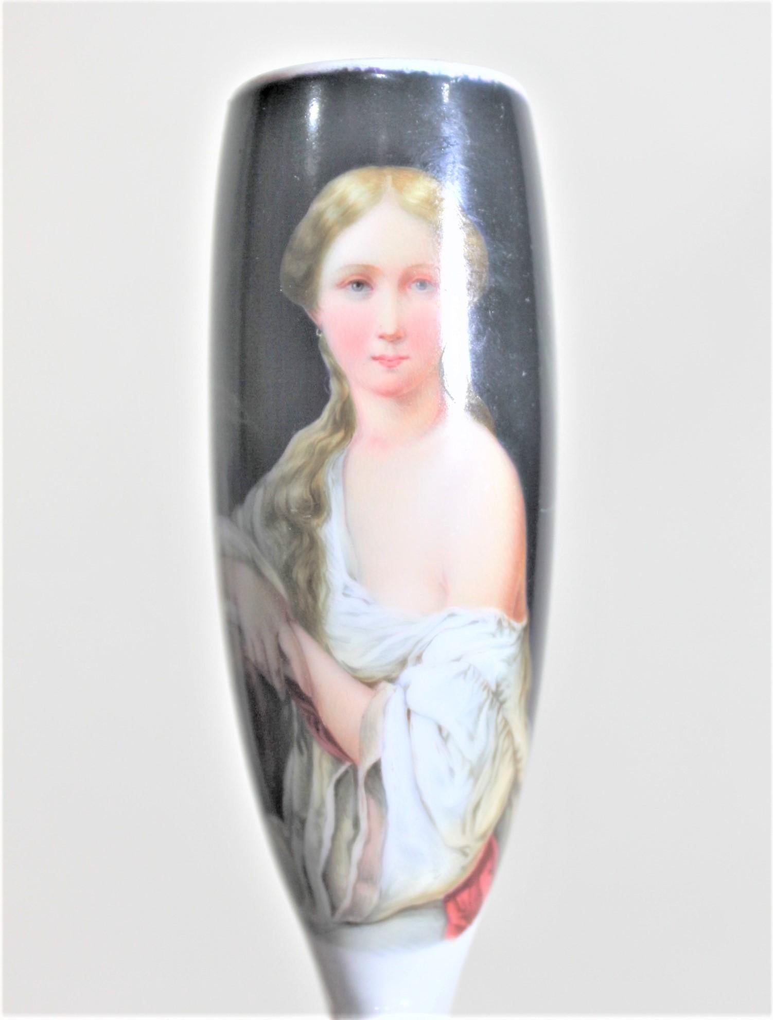 This antique and hand-painted smoking pipe head is unsigned, but presumed to have been made in Austria in approximately 1880 in the period Biedermeier style. This tall pipe bowl has a very well executed hand-painted female portrait in period costume