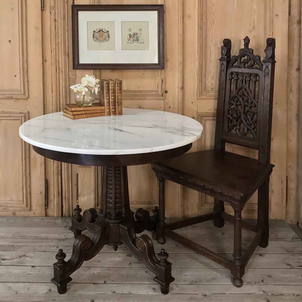 Antique Biedermeir walnut marble top center table is a wonderful example of the woodcrafter's art, with finely shaped pedestal and four scrolled and carved legs supporting the round Carrara marble top which provides carefree enjoyment!,
circa early