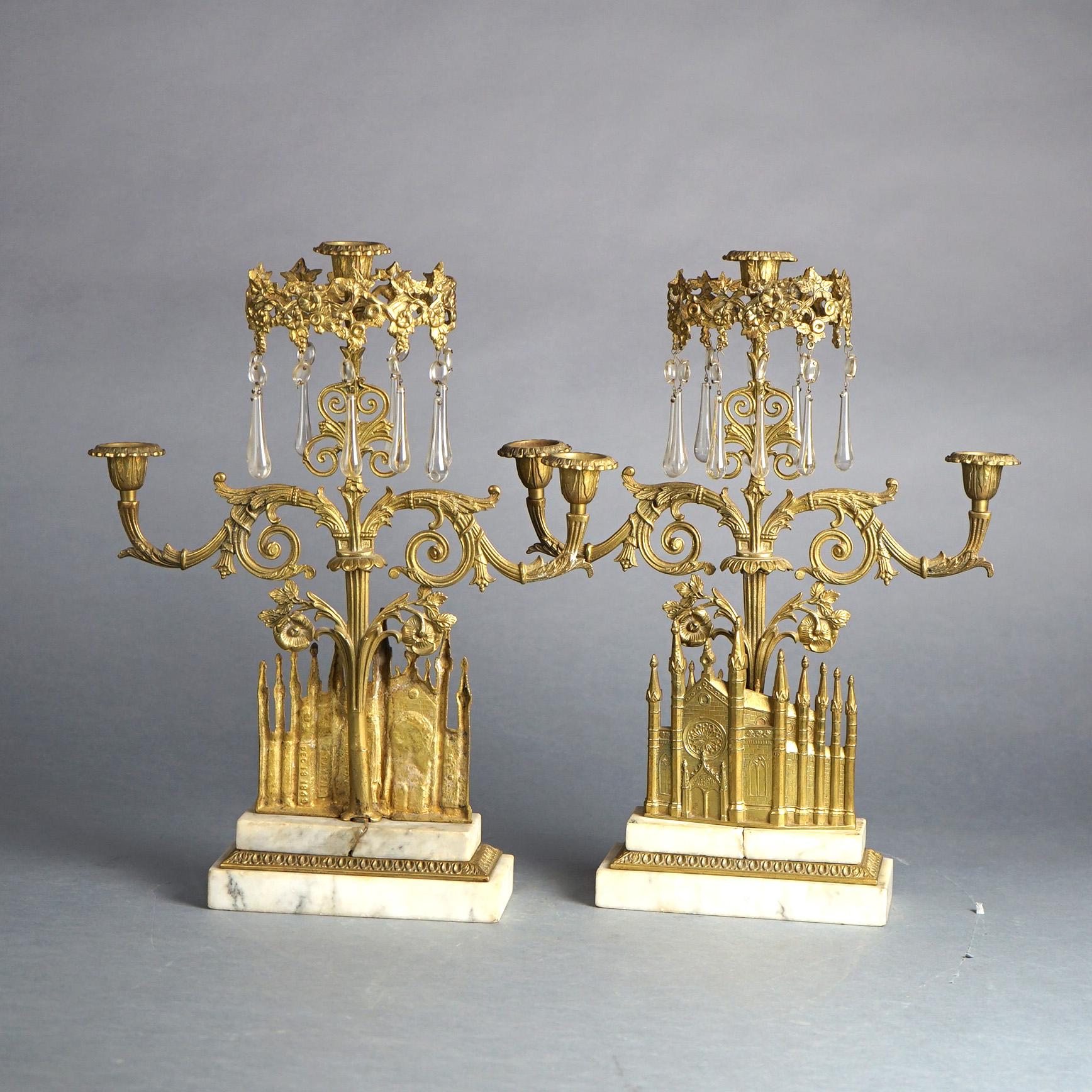 An antique Gothic Revival girandole set offers gilt bronze architectural casting of Bigelow Chapel in Boston, MA surmounted by tree form candelabra with scroll and foliate decorated hanging cut crystals throughout and mounted on marble bases, gothic