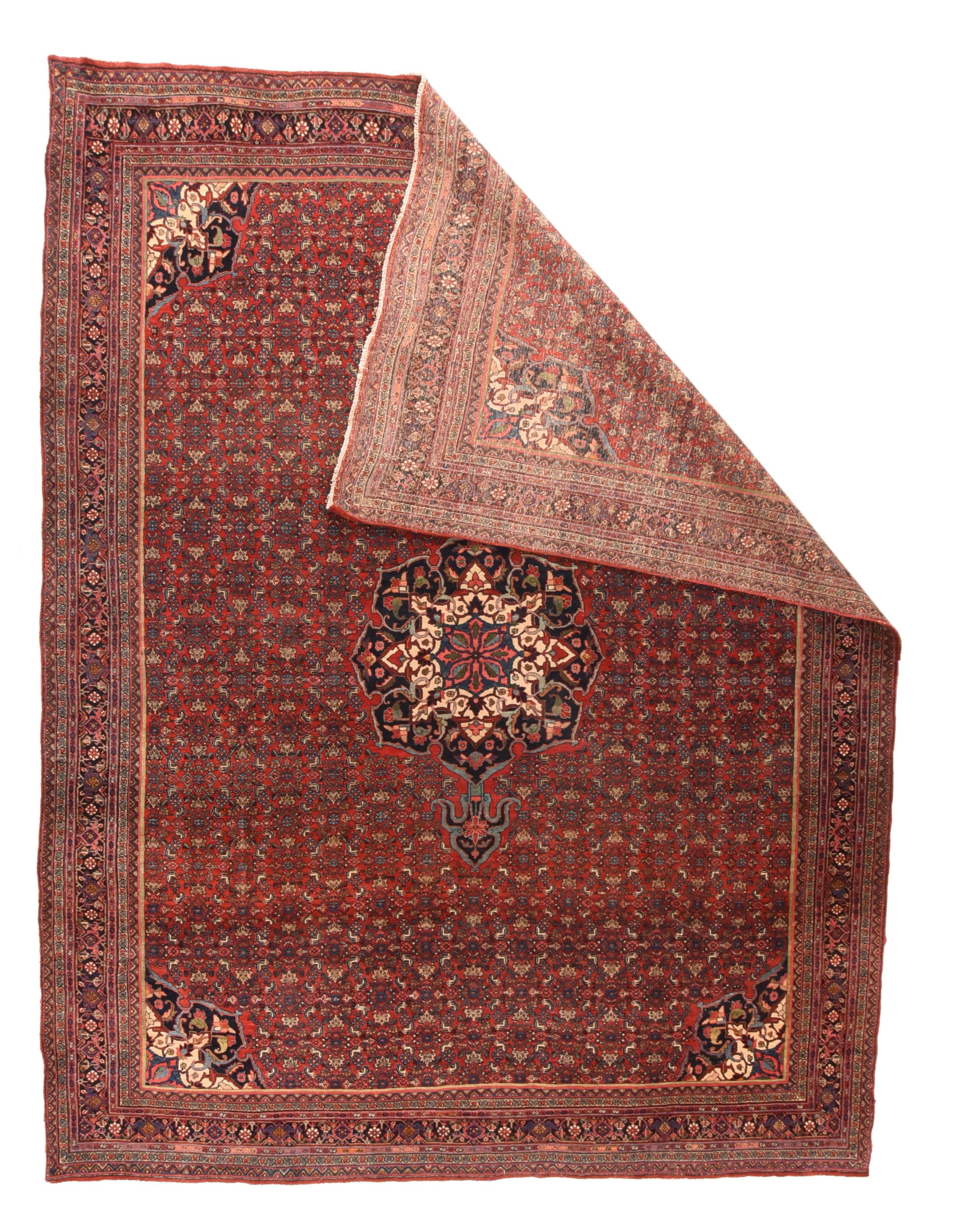 This relatively modern, west Persian Kurdish city carpet on cotton retains the traditional board-like hands and ultra-compact weave. The scarlet field is closely patterned with a small, repeating Herati,. all supporting an octofoil navy medallion