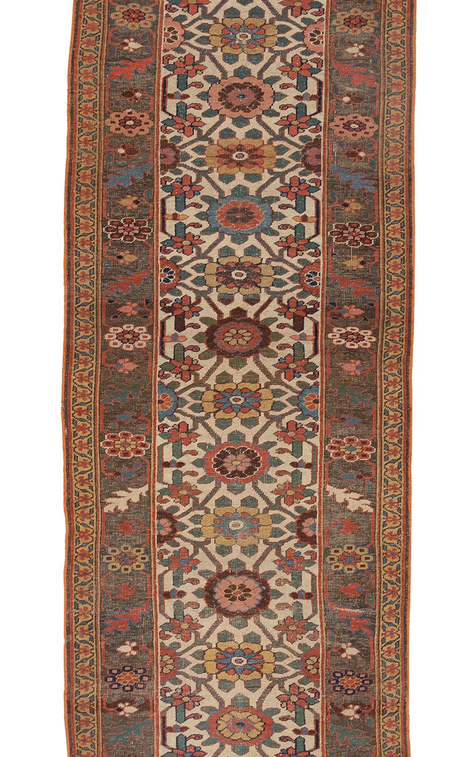 This antique Bijar runner circa 1880s is truly an exceptional piece with a vivid color scheme. It features ornately stylized floral patterns woven in rich vibrant greens, saffron’s, blues, navy, browns, red against a clean ivory field. It is framed