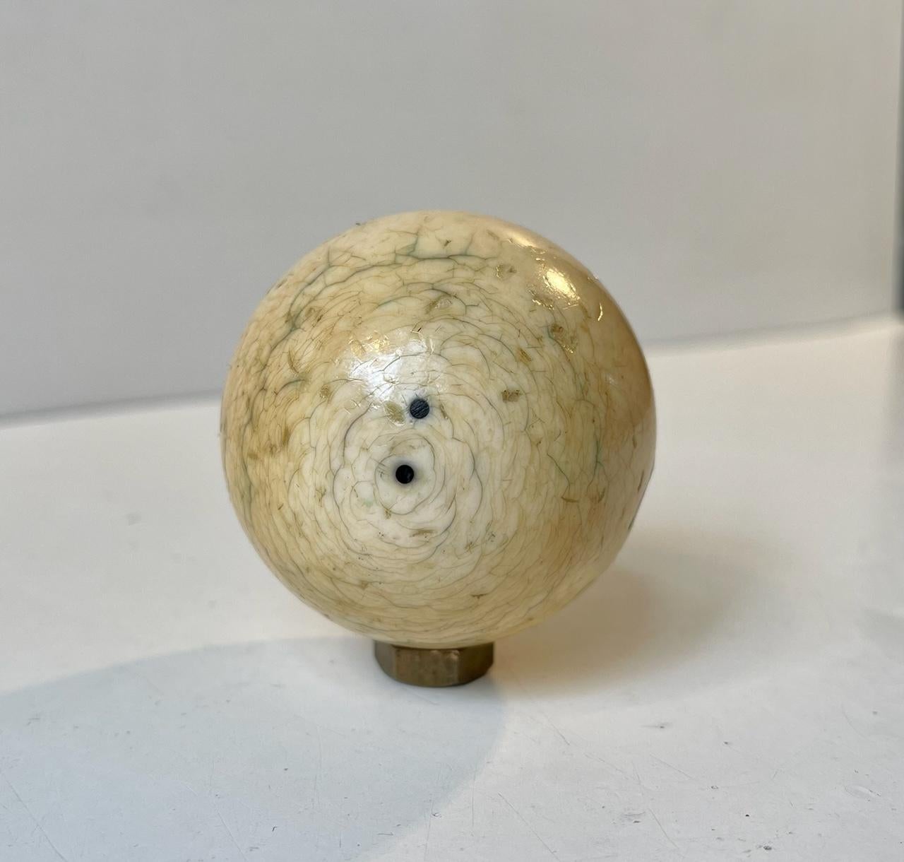 Now serving as a decorative tooth sphere this was originally an object designed for Billiards which was invented in France prior to 1730. This particular cue ball dates to circa 1900. Cites regulations does not apply to objects obviously made prior
