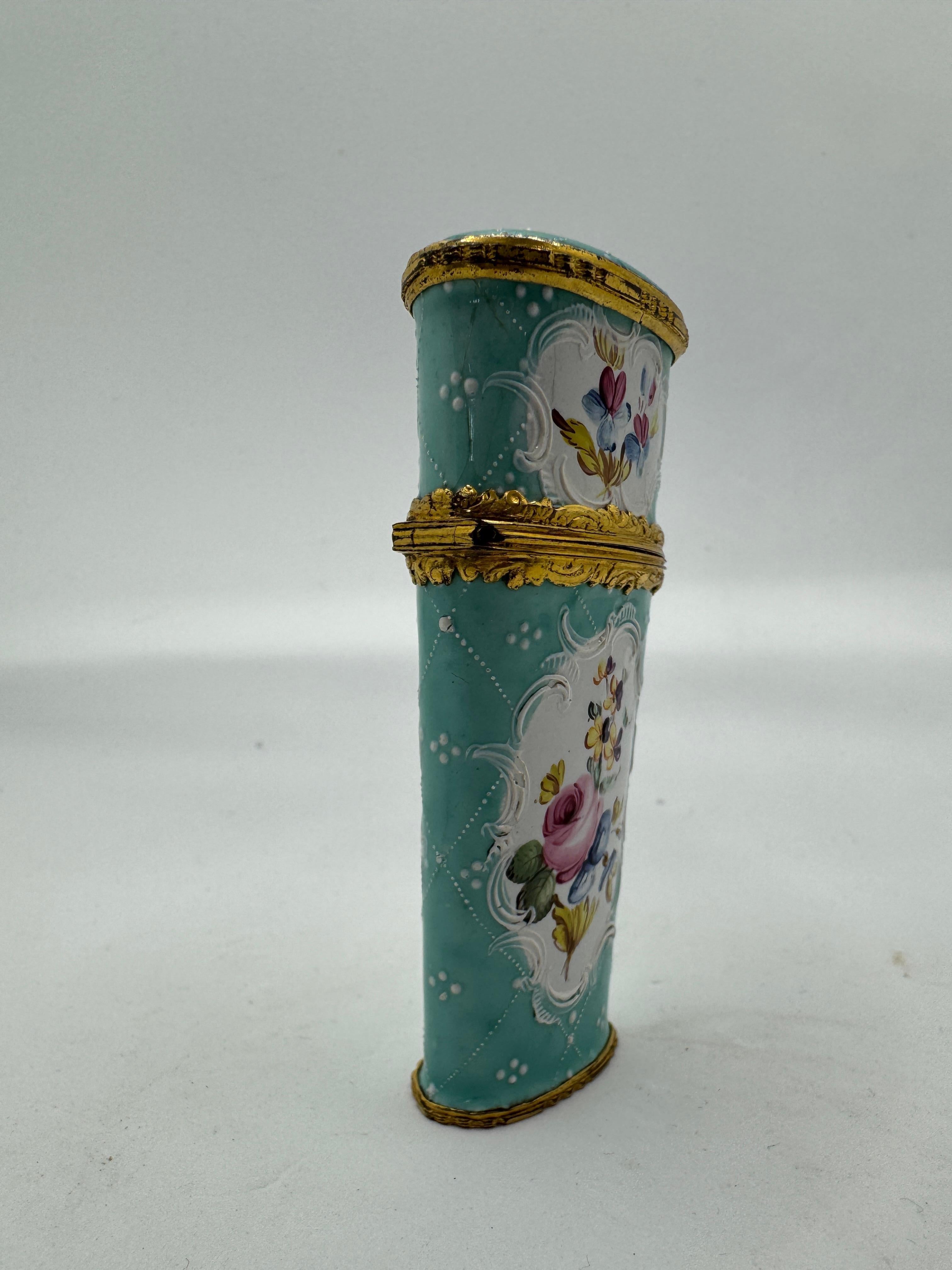 Boîte à couture / Etui en émail du CIRCA du 18e siècle, complète avec son contenu, décorée d'émail sarcelle et d'un cartouche rococo doré contenant des gerbes de fleurs inspirées de natures mortes hollandaises contemporaines, vers 1770.  