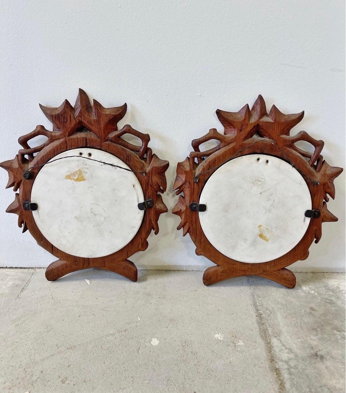 A pair of antique bisque parian ware plaques mounted in finely carved black forest frames. Ready to hang!