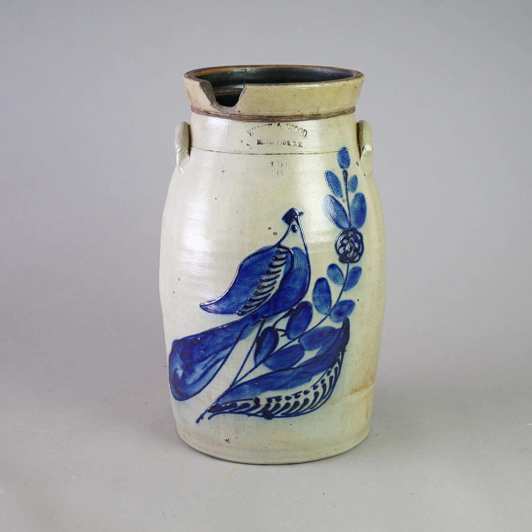 An antique Binghamton White and Wood churn crock offers stoneware construction with double handles, blue decorated with a paddle bird, and maker stamped, c1870

Measures - 18.25
