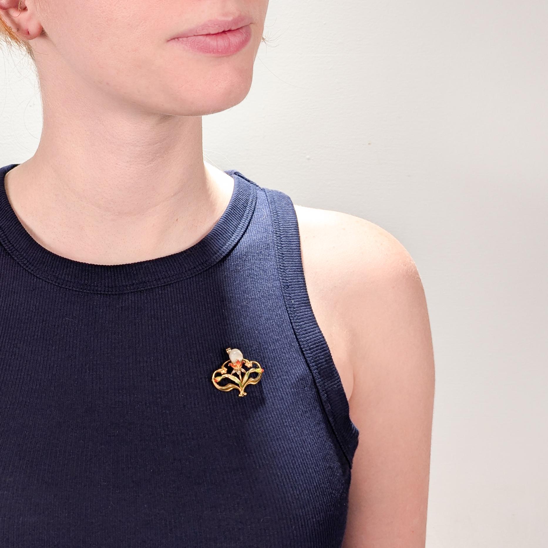A fine antique American Art Nouveau convertible brooch or pendant.

In 14 karat yellow gold. 

By Bippart & Co.

In the form of a flower with the baroque pearl as the stigma of a green and red enameled flower.

Marked to the reverse for Bippart &