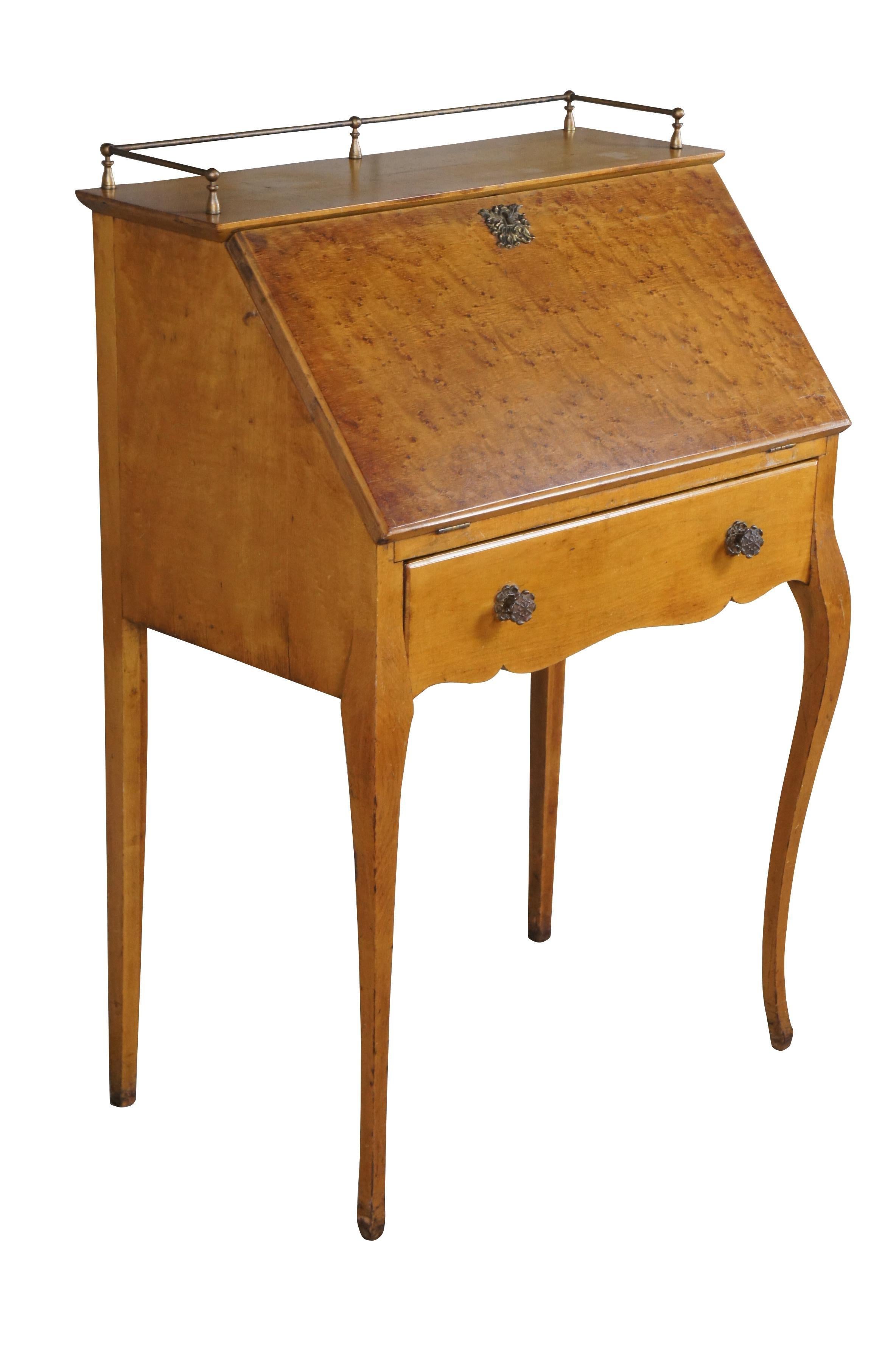 Antique secretary / library writing desk.  Made of  Birdseye Maple featuring drop door that opens to writing surface with multiple cubbies for storage, one large drawer, brass gallery and serpentine front legs.

Dimensions:
26.5