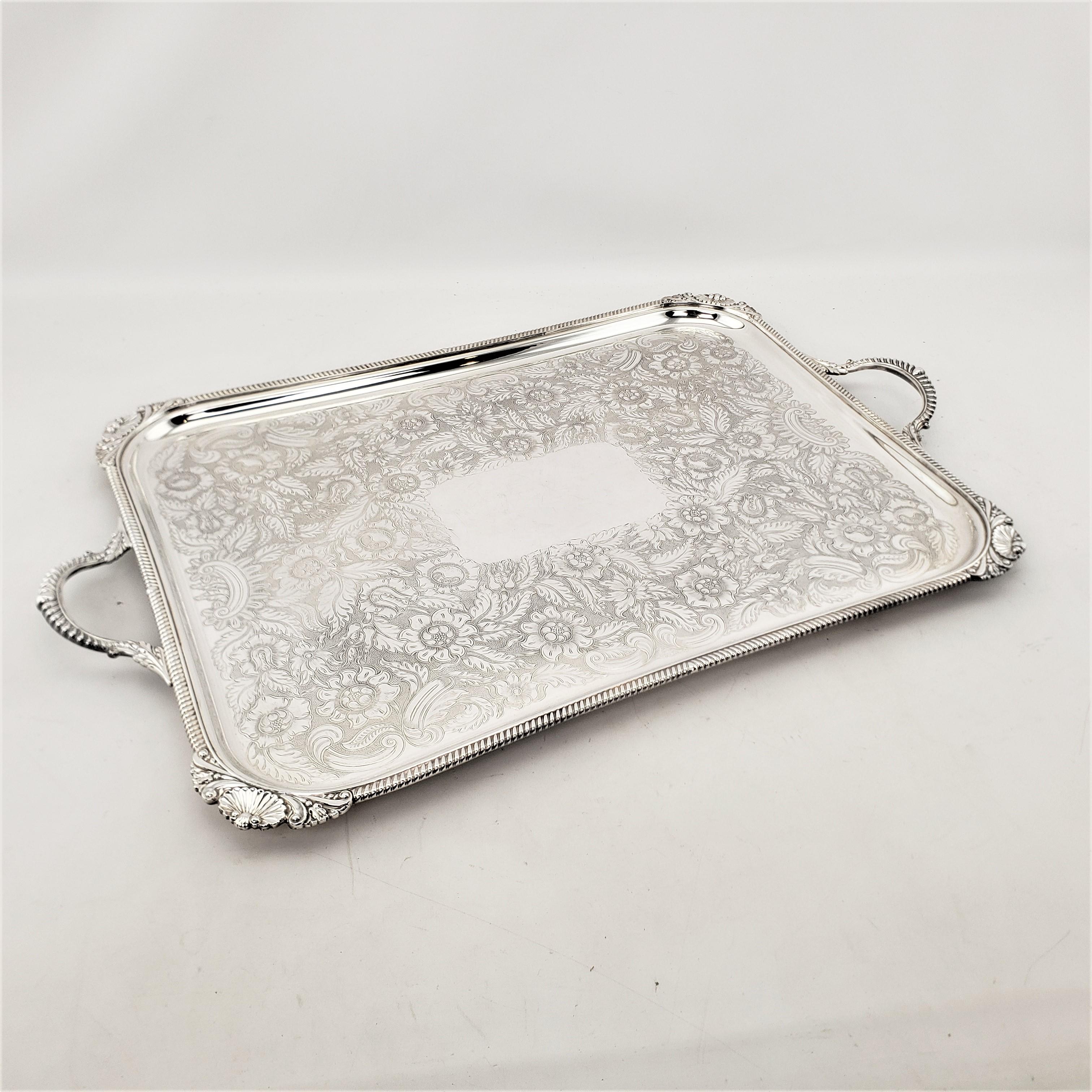 This silver plated serving tray was made for the renowned Birks department store chain, most likely by a maker from the United States in approximately 1920 in a Victorian style. The serving tray is rectangular in shape with a rope styled edge and