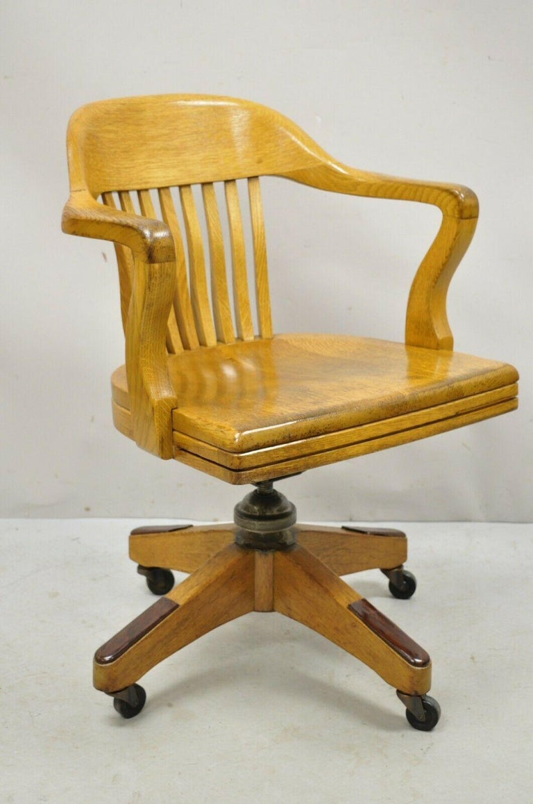 Antique B.L. marble oak rolling lawyers banker office desk chair. Item features adjustable height, rolling casters, solid wood construction, beautiful wood grain, original label, very nice vintage item, quality American craftsmanship, great style