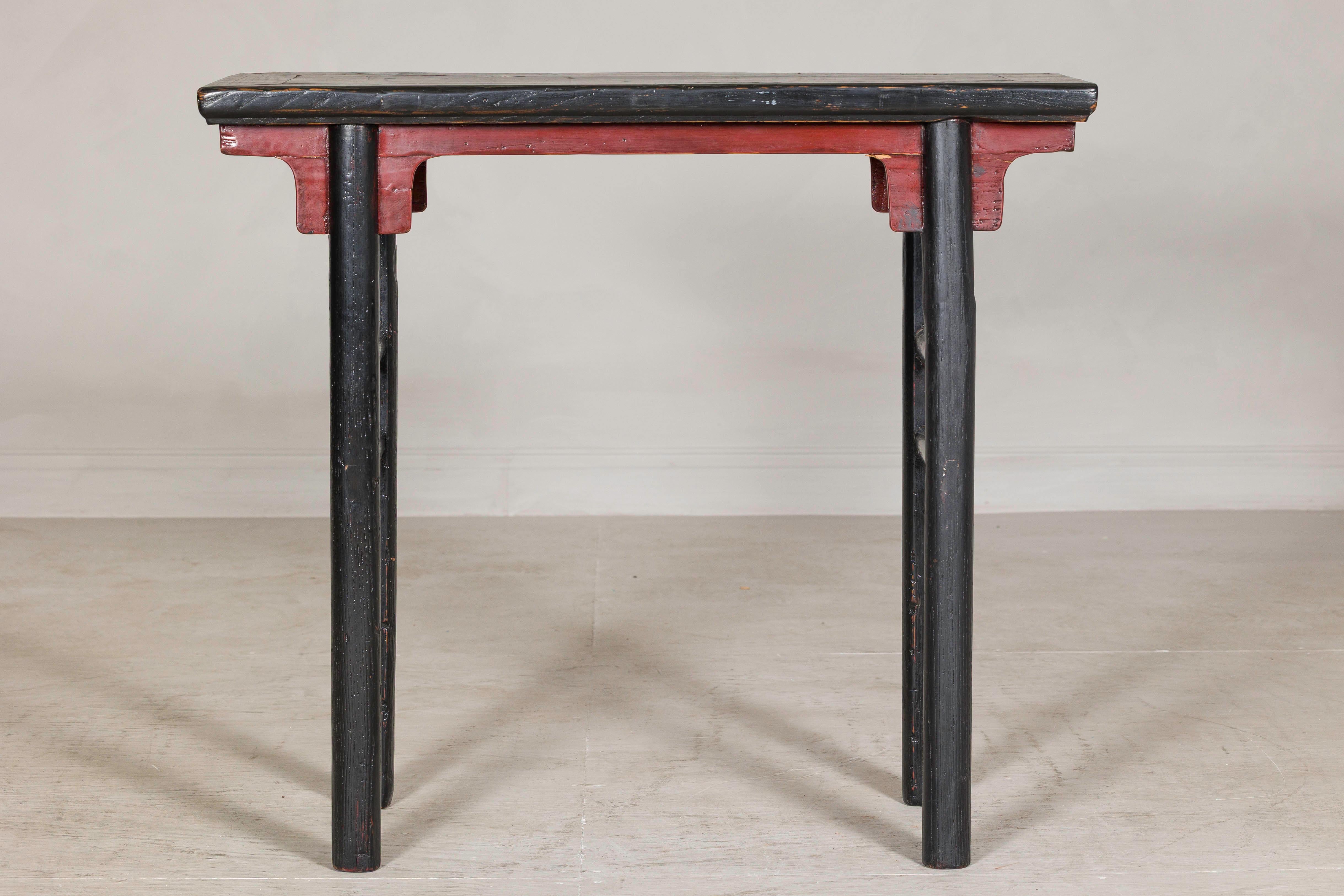 A late Qing dynasty wine table with bold architectural lines and a striking red-and-black lacquered finish. Likely originating from Northern China, this antique table was traditionally used for serving wine or tea and features a narrow rectangular