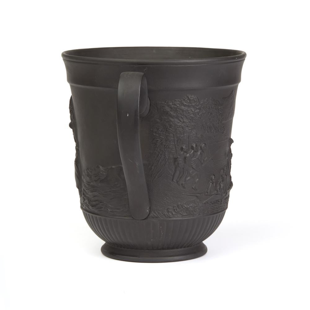 A very fine antique black basalt two-handled Captain James Cook commemorative loving cup of rounded bucket shape with large ear shaped handles either side. The cup is crisply relief moulded with excellent detail with a profile of Cook to one side