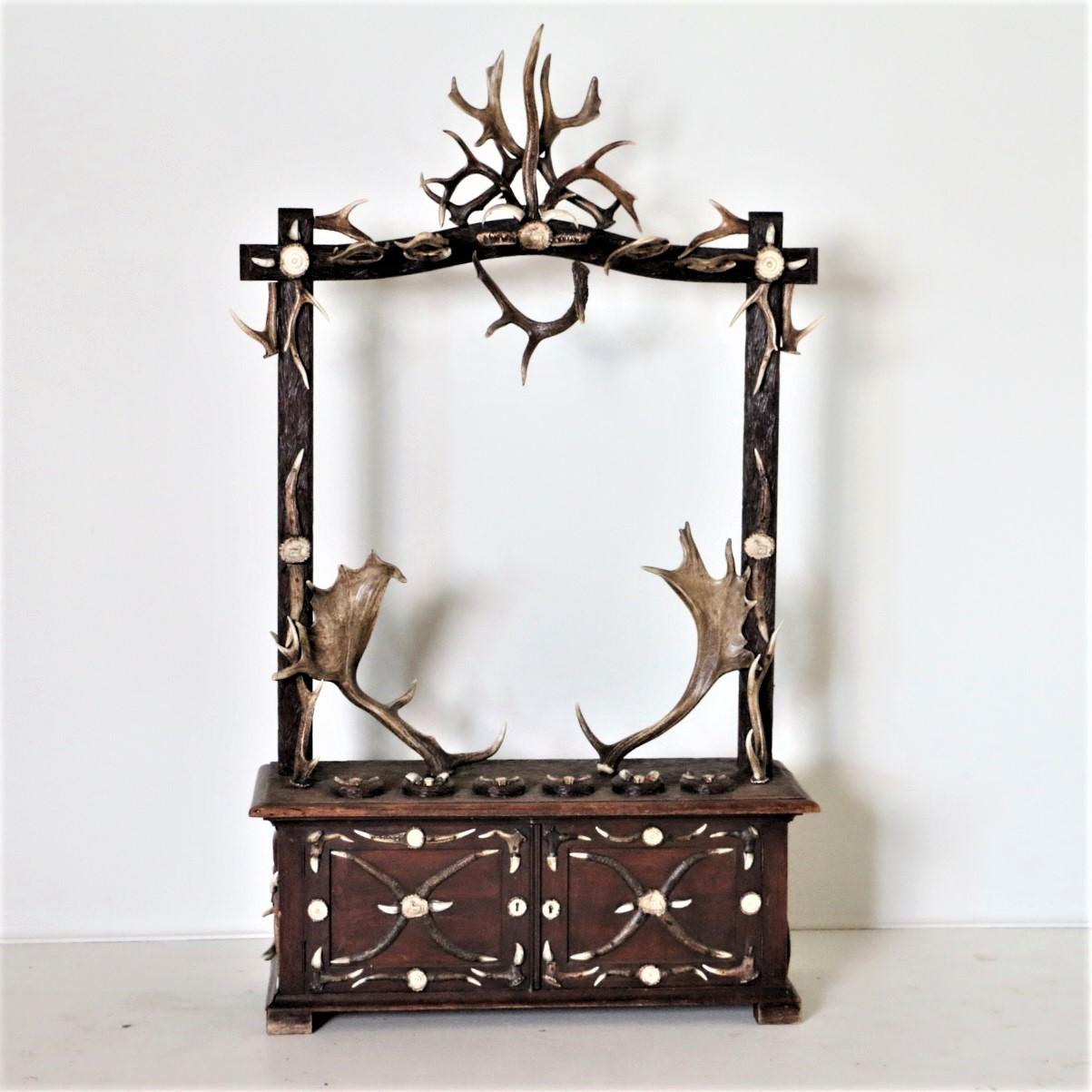 This highly unusual gun rack is from the famous Black Forest region of Germany. Spectacular details include multiple antler 