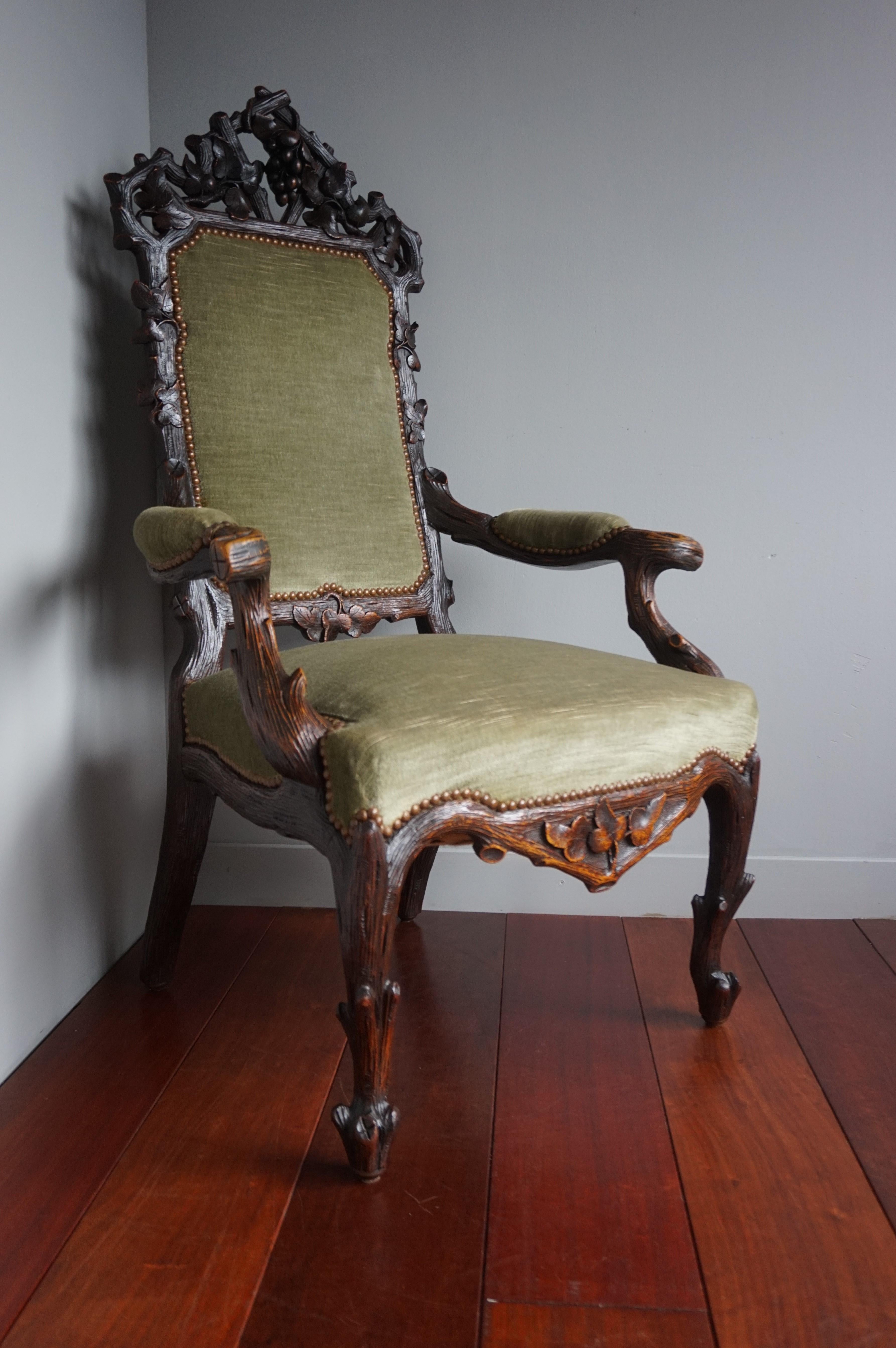 Unique and impressive armchair with green upholstery. 

This stunning chair is as strong and stabile as the day it was made and the woodwork is in excellent condition also. The solid and exceptionally hand carved oak frame comes with a variety of