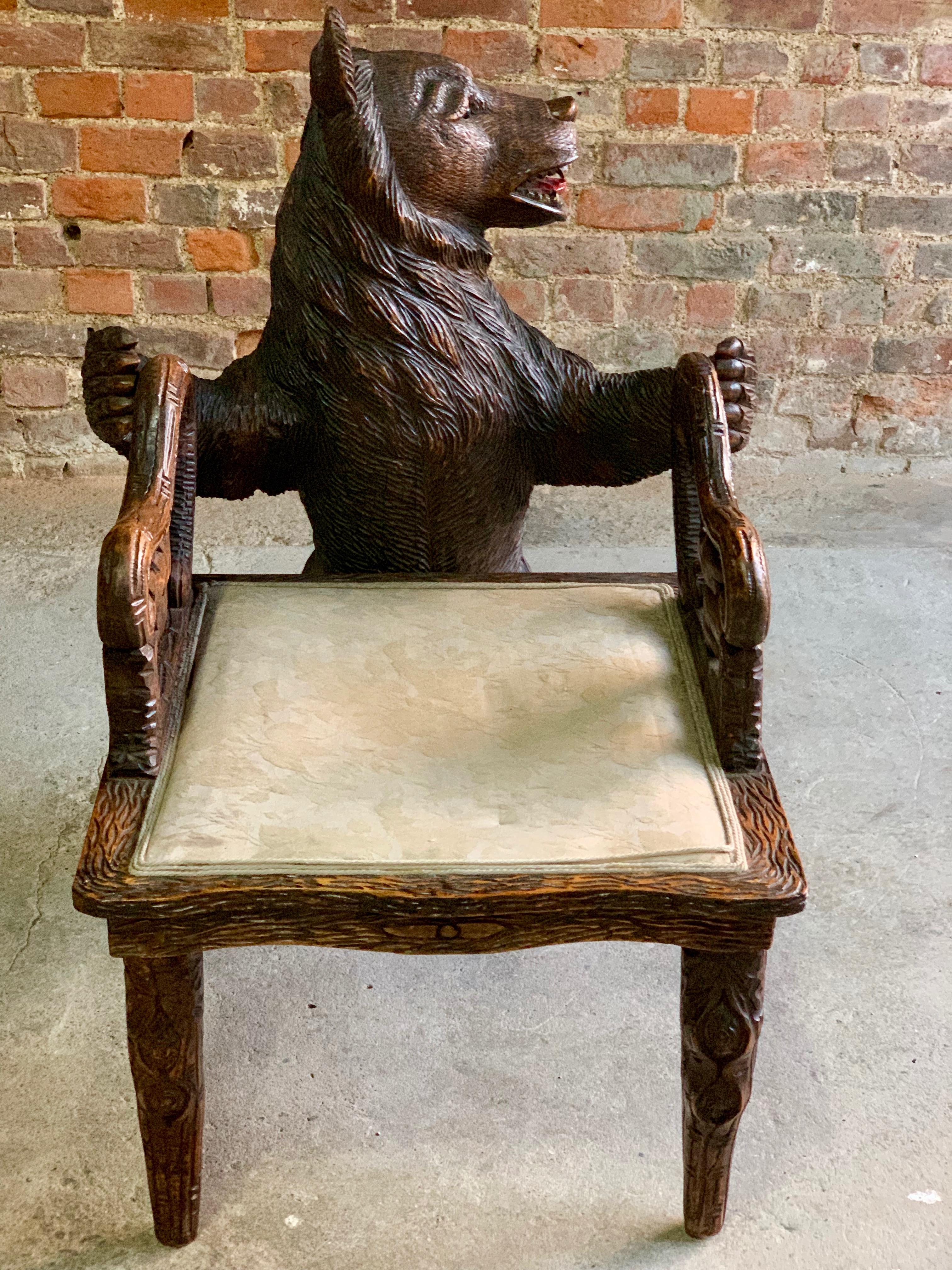Magnificent Swiss 19th century Black Forest carved bear hall chair circa 1875, the bear standing on his hind legs looking to his left with his mouth open showing teeth and tongue with a bewildered look in his eyes, his front paws outstretched