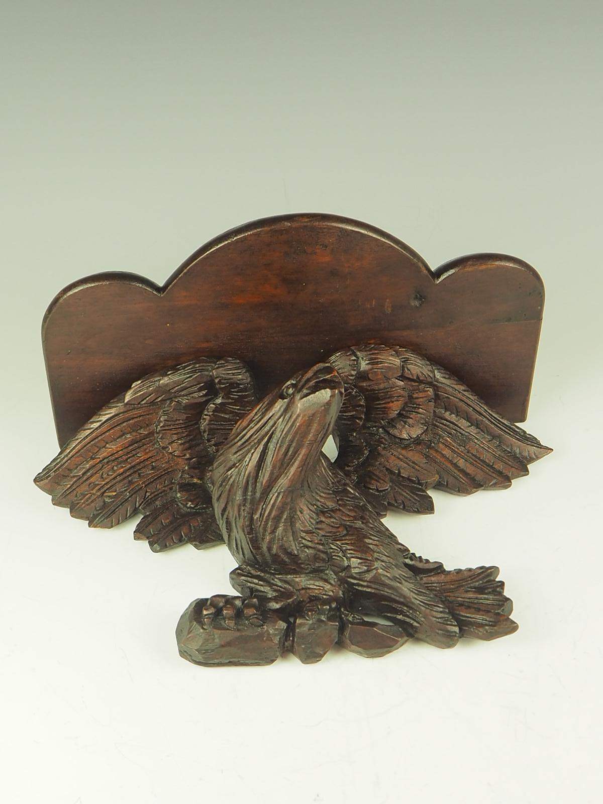 Antique Black Forest Carved Eagle Shelf is a stunning piece of craftsmanship that combines functionality with intricate design. Made in the renowned Black Forest region of Germany, this shelf showcases the traditional carving techniques that have