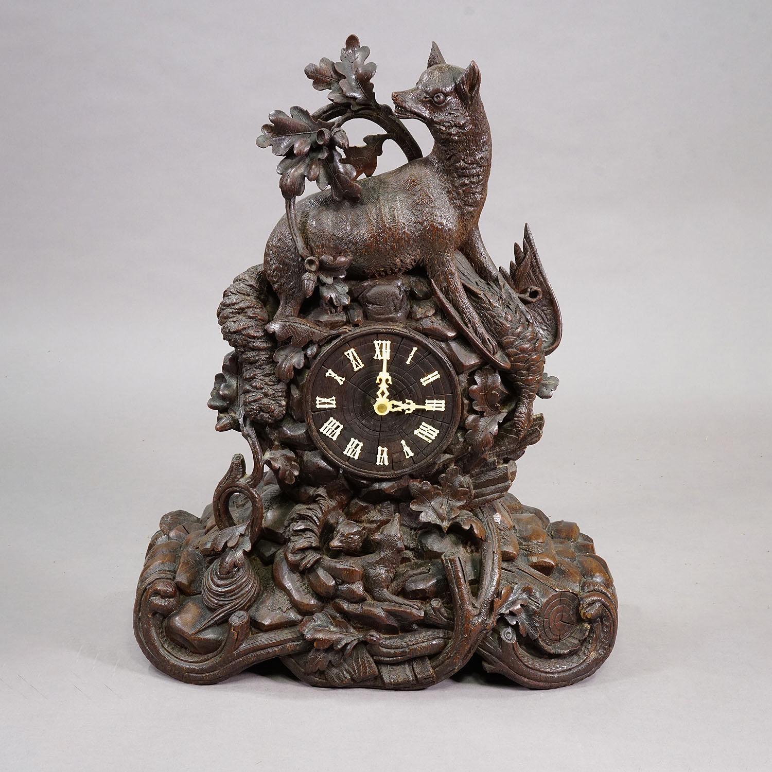 Antique Black Forest Clock Set with Carved Hunting Motifs, ca. 1900

This antique Black Forest clock set, dated around 1900, includes a carved mantel clock and two matching side pieces with hunting motifs. The clock features a wooden case with a fox