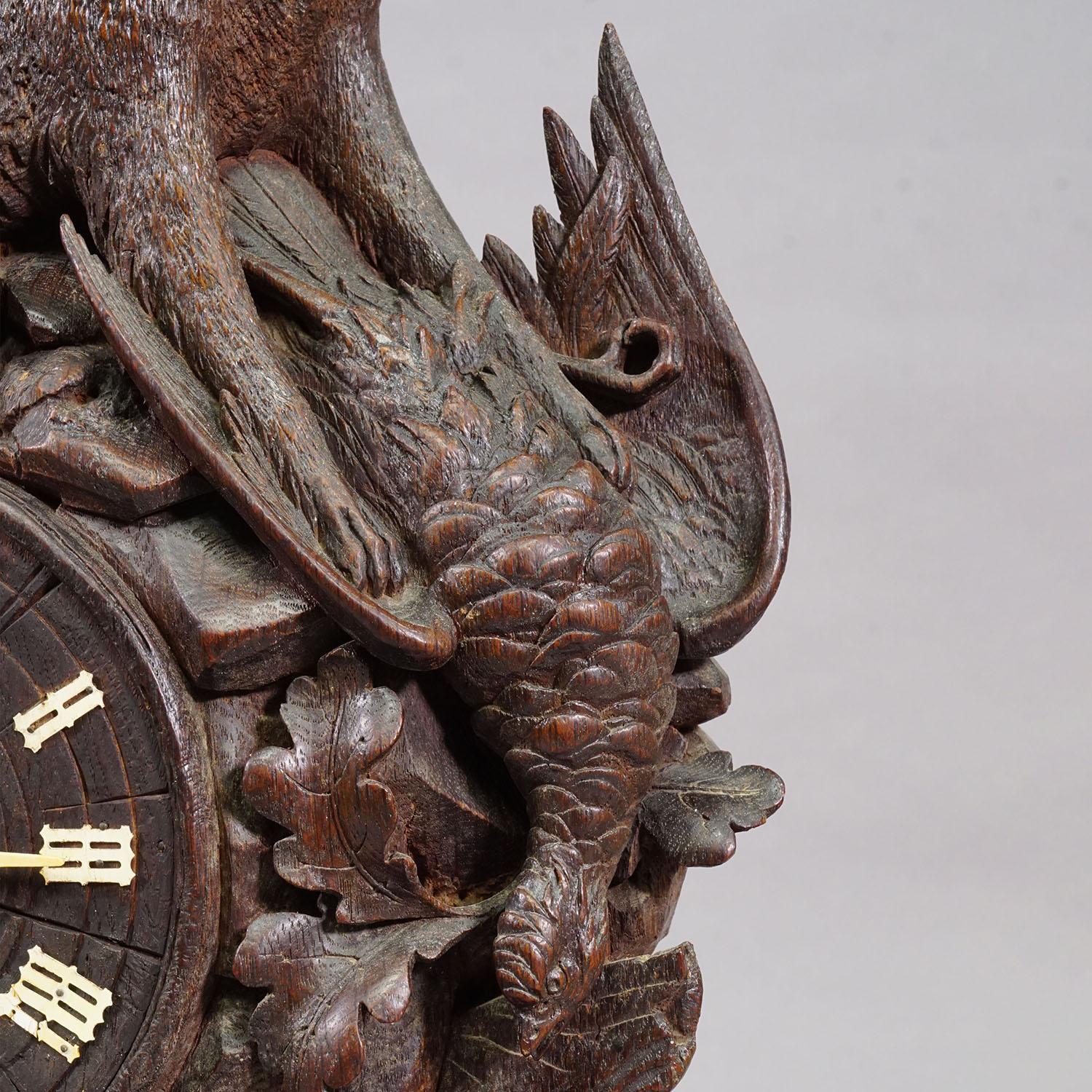 Wood Antique Black Forest Clock Set with Carved Hunting Motifs, ca. 1900 For Sale