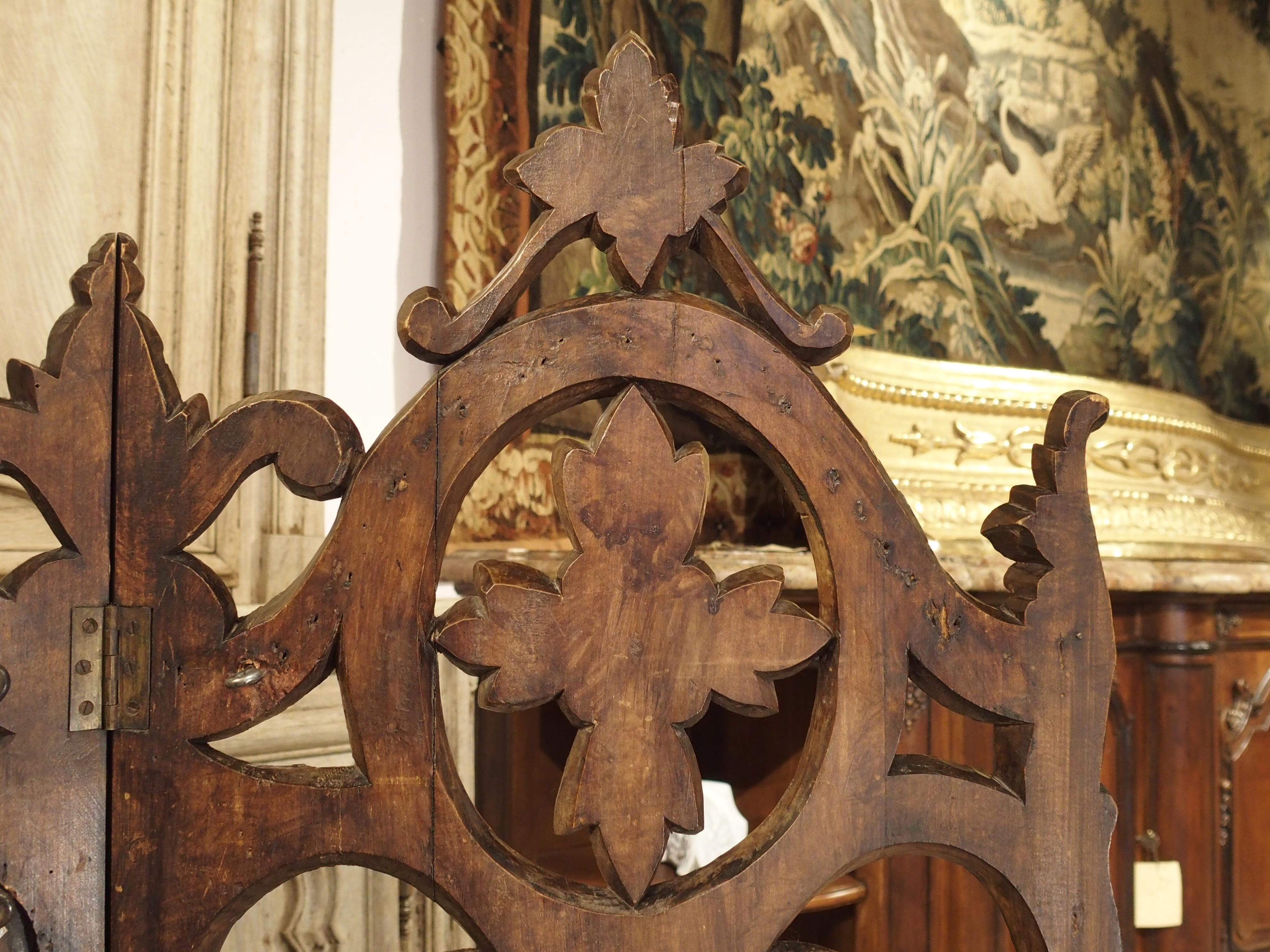 From France, this unusual, three paneled, wooden firescreen has beautiful details of foliate and tree bark motifs, typical of the Black Forest style. There are depictions of wooden branches and twigs in C-and S-scroll, Fleur-de-Lis, and acanthus