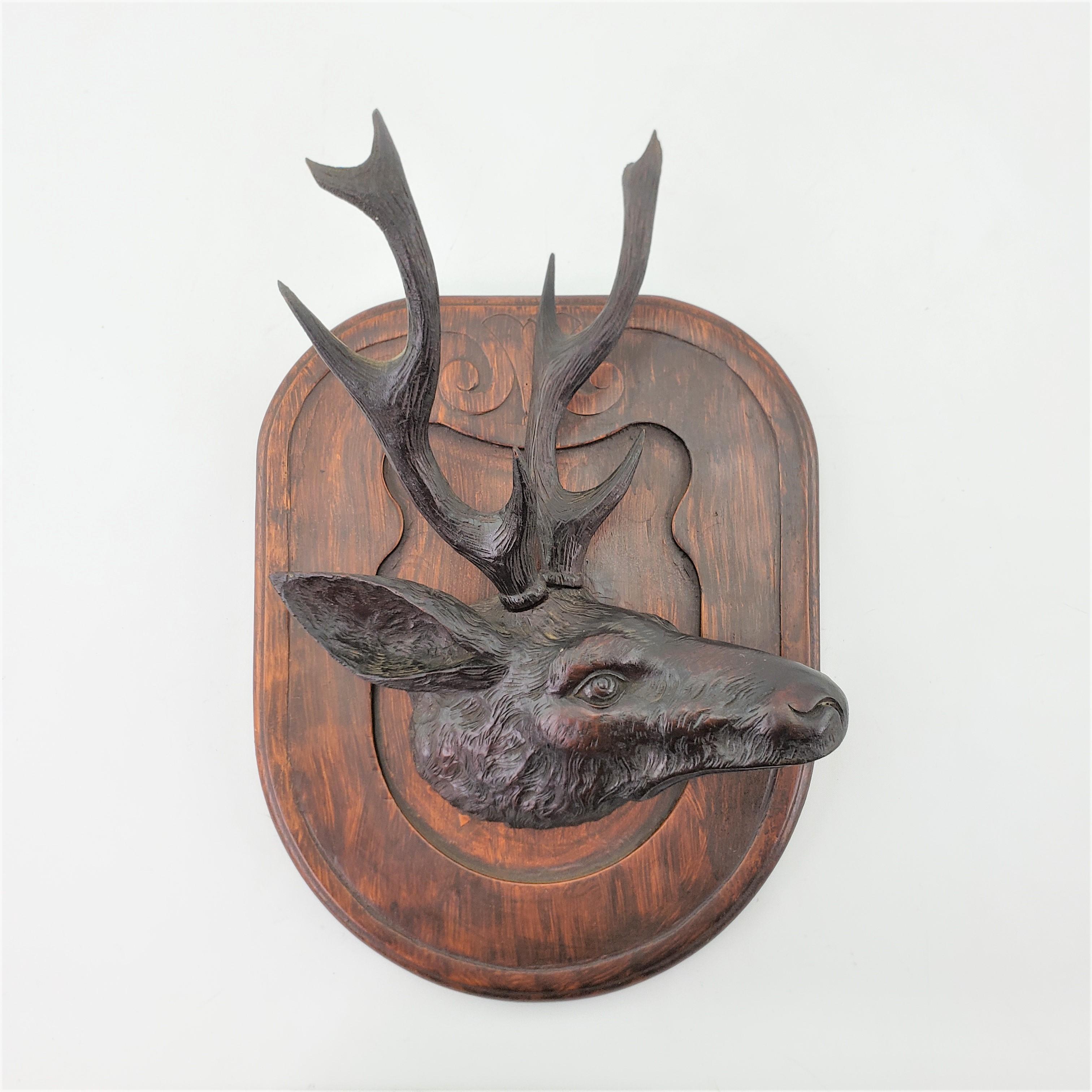 This well executed antique wall sculpture is unsigned, but presumed to have been done in Switzerland in approximately 1890 in the period Black Forest style. This hand-carved sculpture depicts the head of a deer or elk and is mounted on a wall plaque