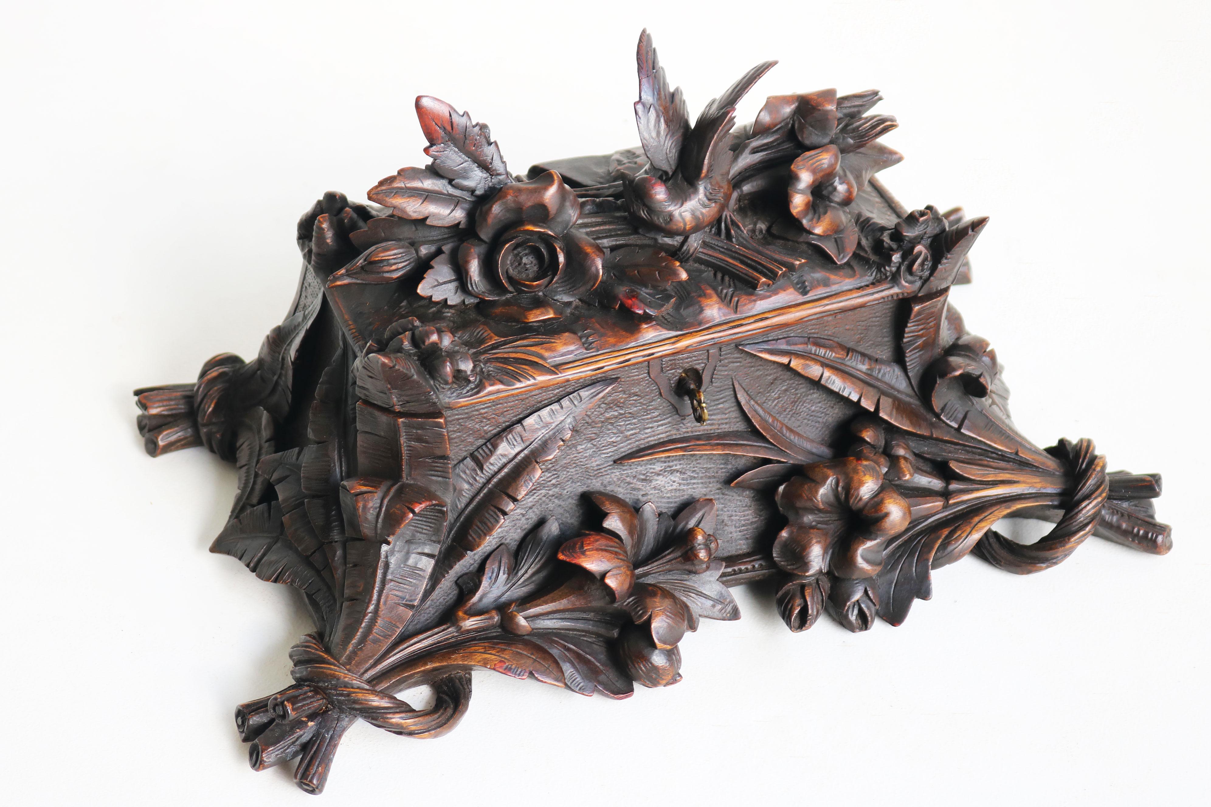 A true work of art, this stunning 19th-century Black Forest jewelry box from Switzerland is fully hand-carved and a remarkable example of craftsmanship. Nearly 150 years old, the wood has developed a rich patina that only enhances its charm. Carved