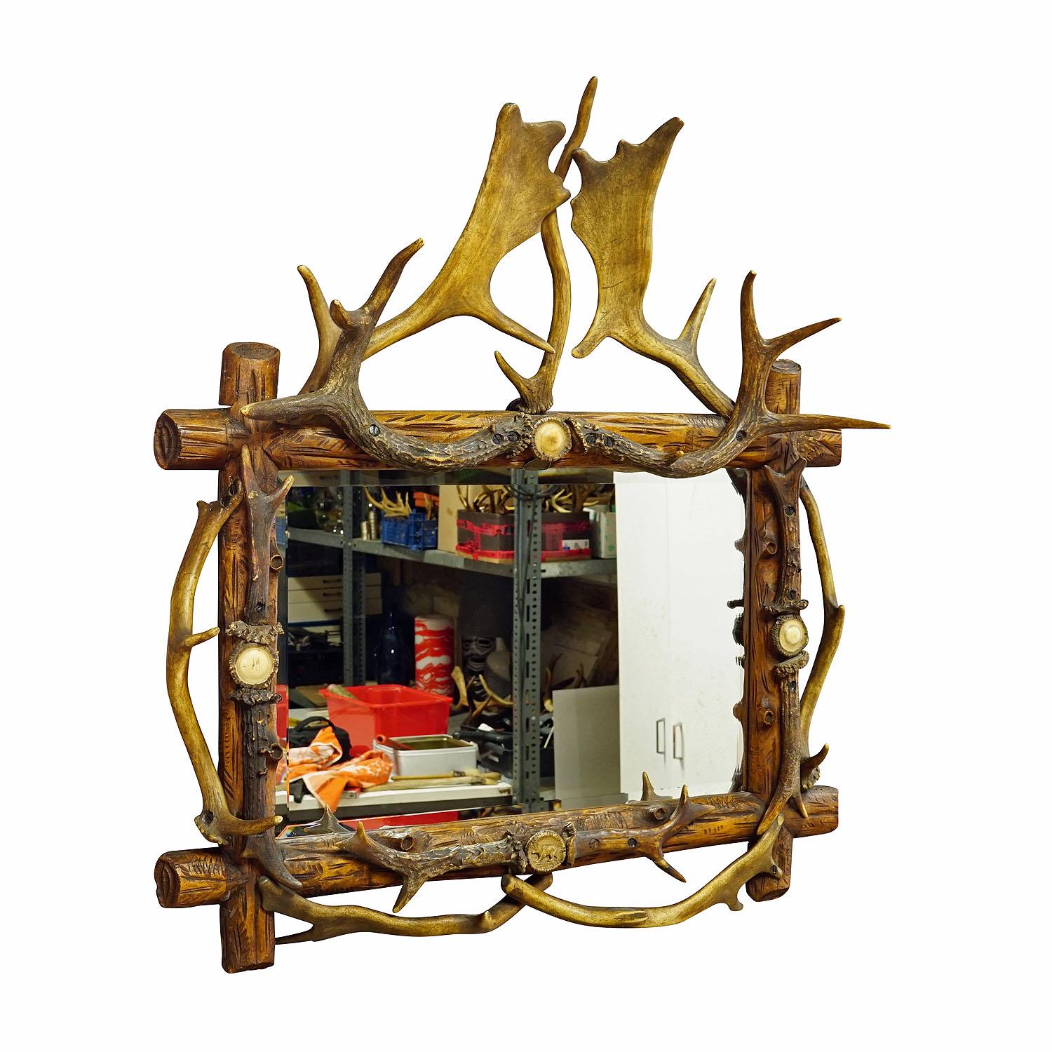 Antique Black Forest Mirror with Rustic Antler Decorations ca. 1900
Item e7339
A large and impressive antler mirror with a wood-carved frame decorated with large carved and turned horn roses and pieces of antler from stag, fallow deer and