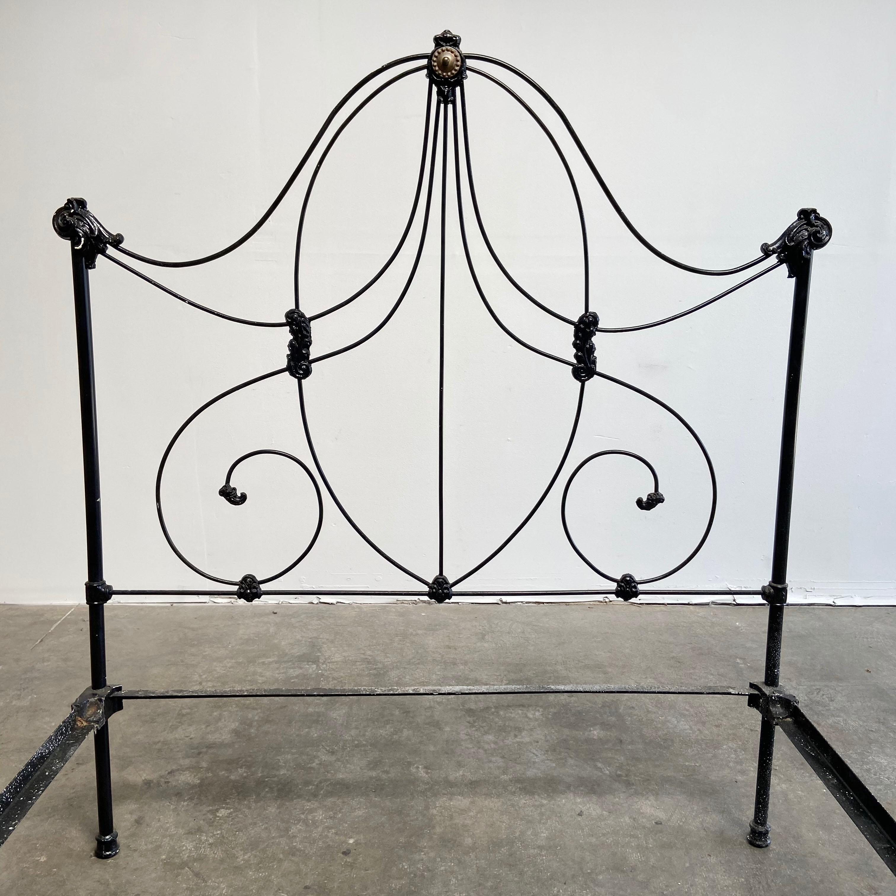 Beautiful antique iron bed with rails ready to set up and use. Solid black painted iron with brass details.
This is ready for a double or full size US Mattress. The caster wheels are removable if needed. They are original. The bed is super solid