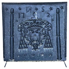 Antique Black Iron Fireback with a Tasseled Crest