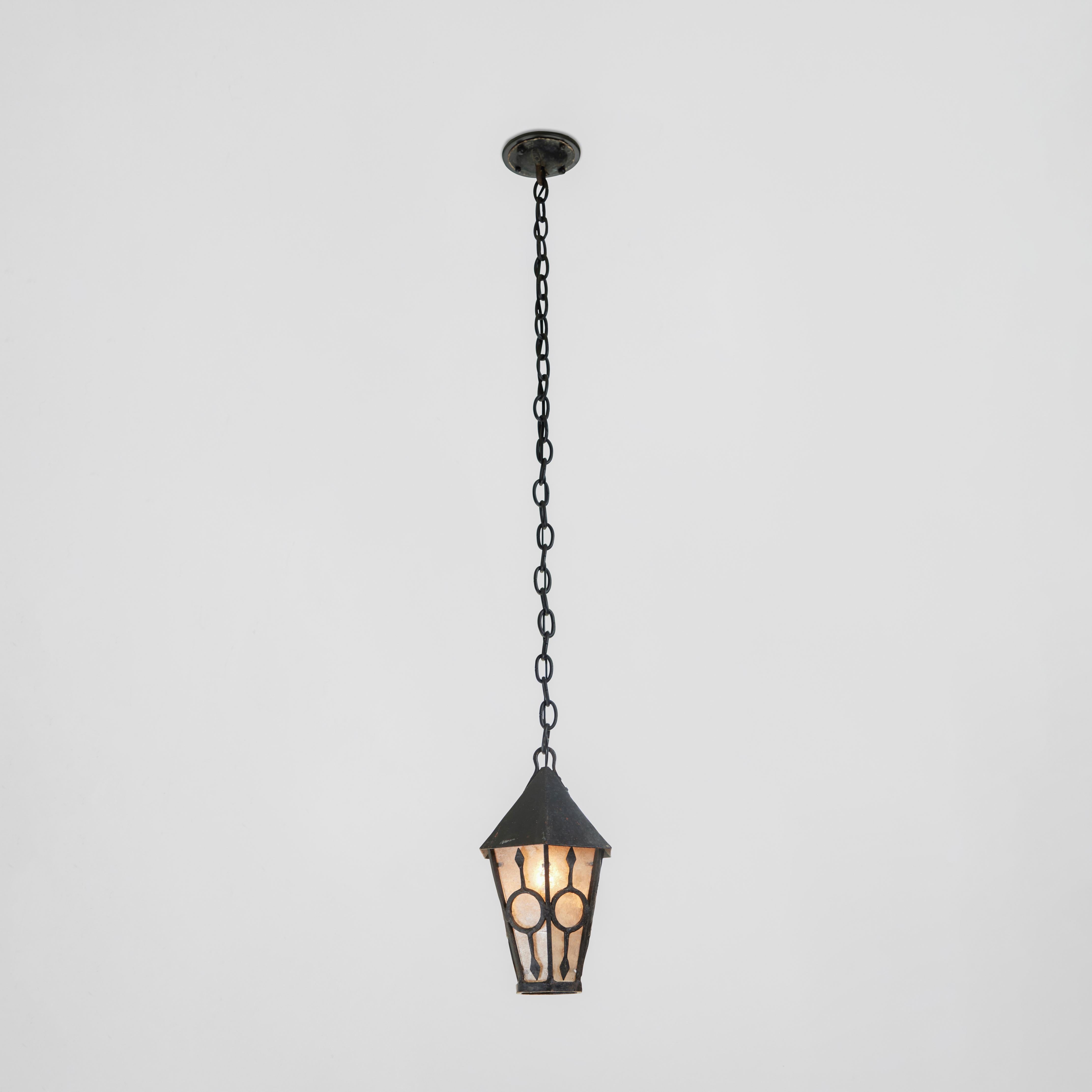 This small antique black iron hanging lantern has a large presence. Newly rewired, it has new mica inserts. A perfect accent in that special space!