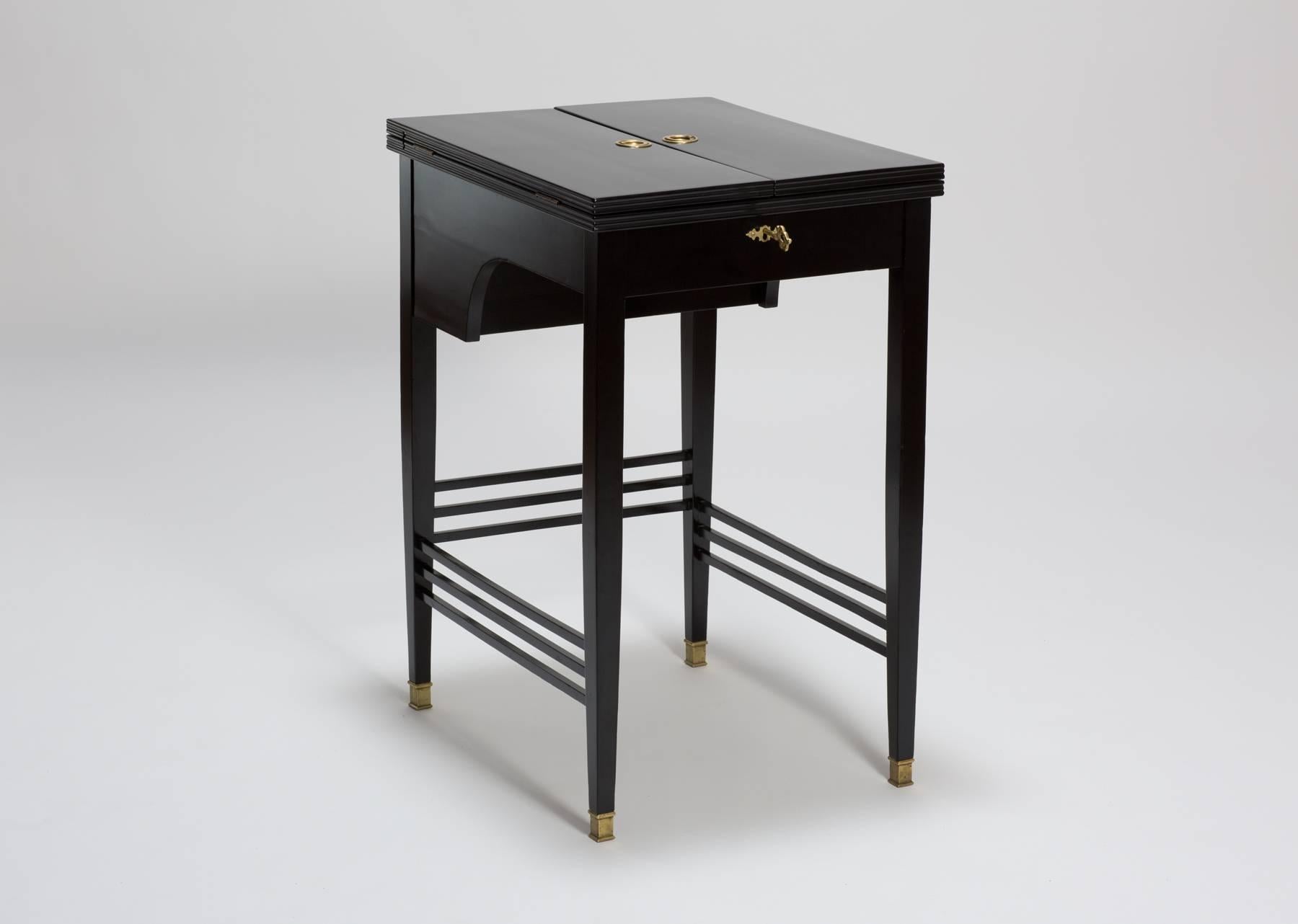A very elegant antique Art Nouveau writing desk From Vienna. The table is black lacquered with brass mountains.
The writing table has a foldable mechanism. If the desk is closed, it looks like a nice side table. If you pull the two brass rings on
