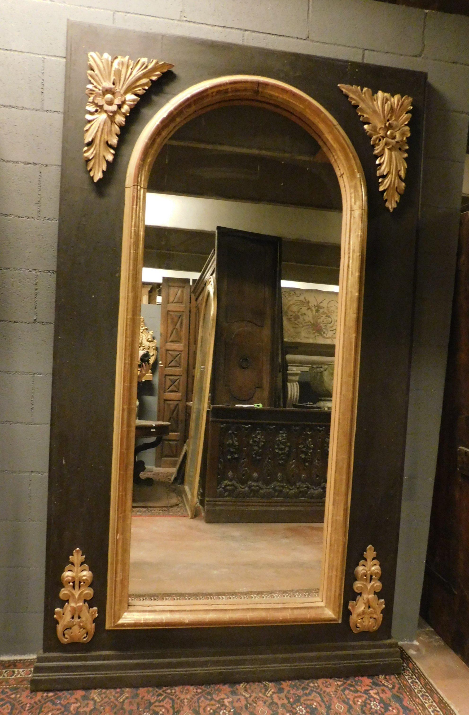 Antique black lacquered mirror, with golden decorations friezes, ancient well preserved original. Originally it was placed over a fireplace, in a house with high ceilings, it can now be placed on the ground or on the wall, ideal also in the bathroom